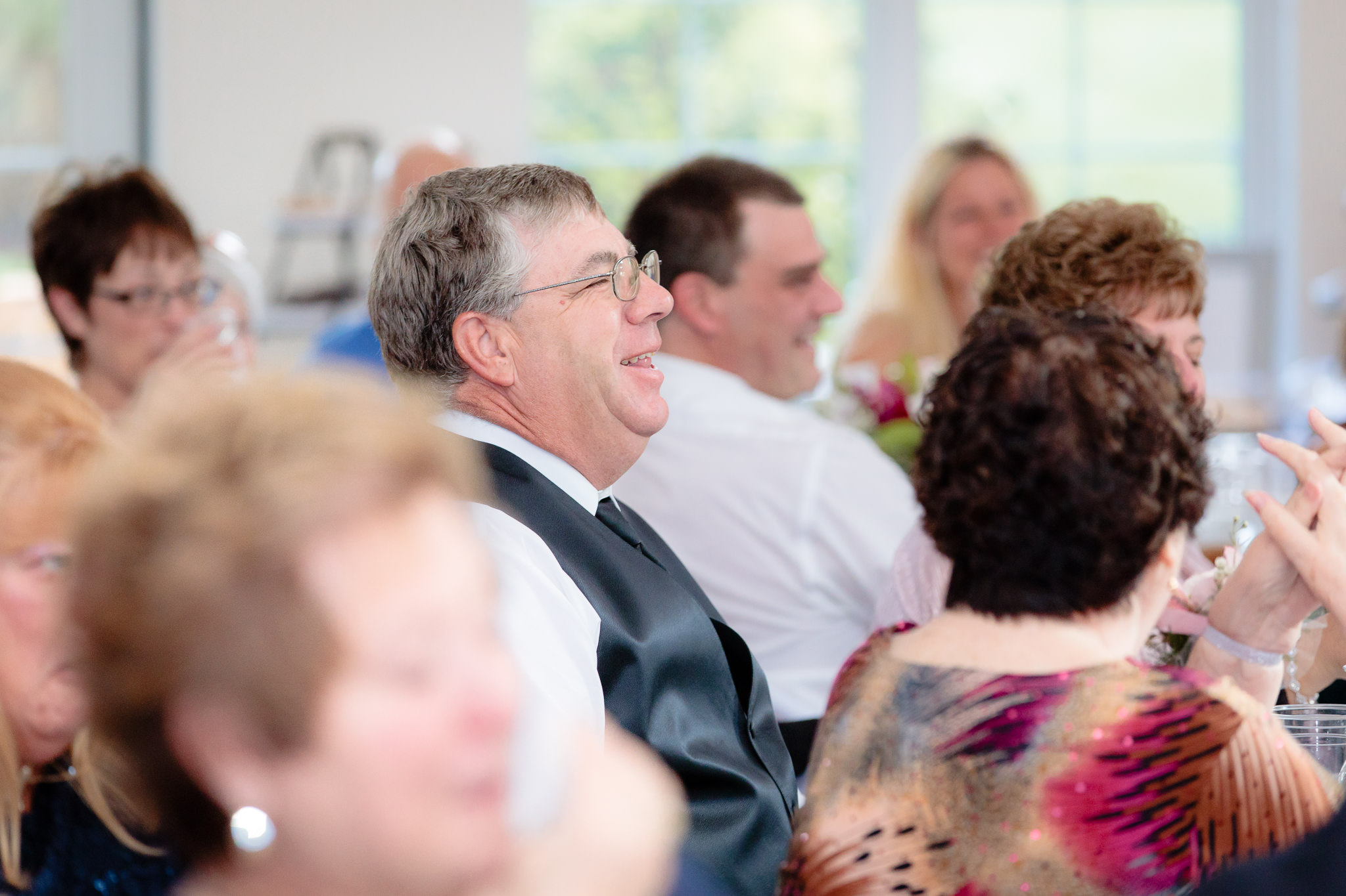 Father of the groom laughs during speeches at a Greystone Fields wedding