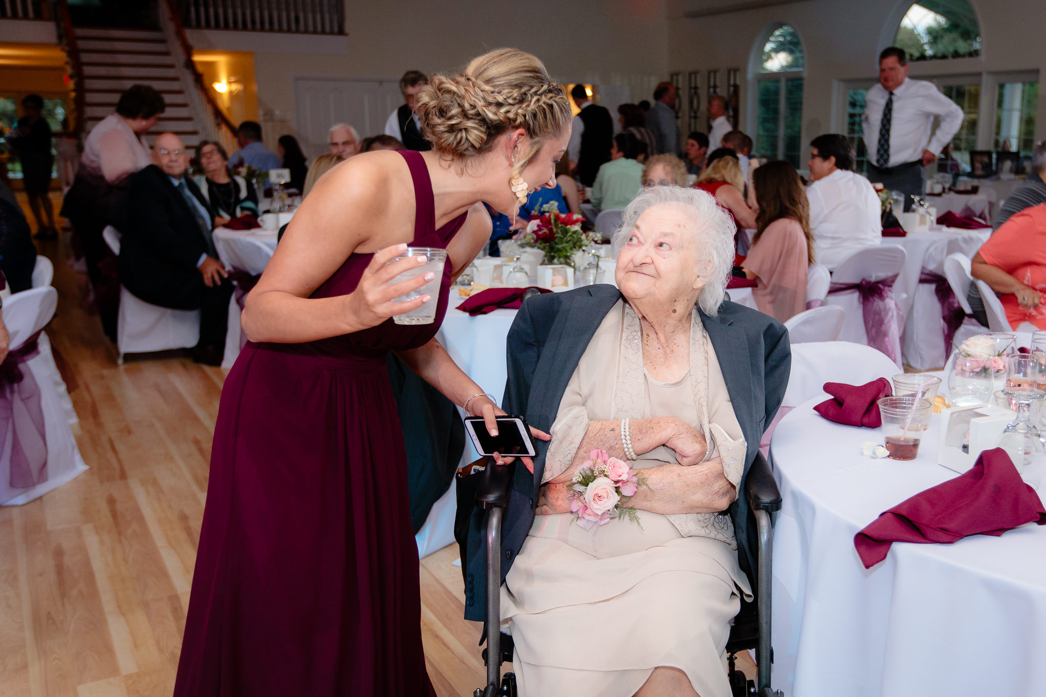 Bridesmaids talks with grandmother of the bride at Greystone Fields