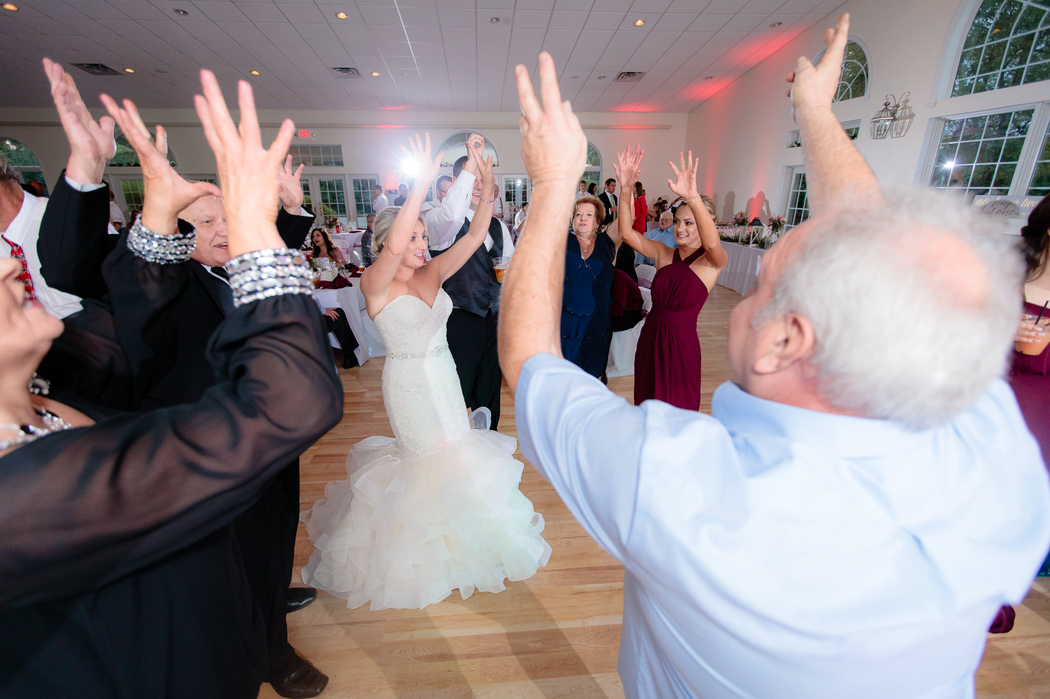 Bride dances with guests at a Greystone Fields wedding