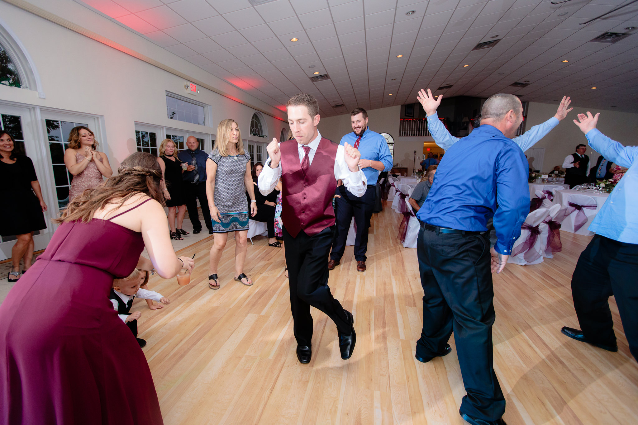 Groomsman dances at a Greystone Fields wedding reception