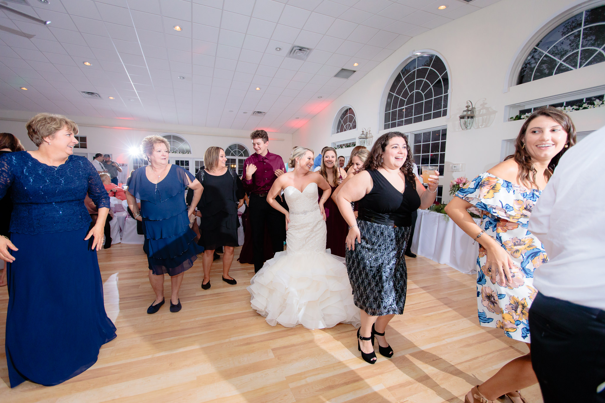 Guests do a line dance at a Greystone Fields wedding