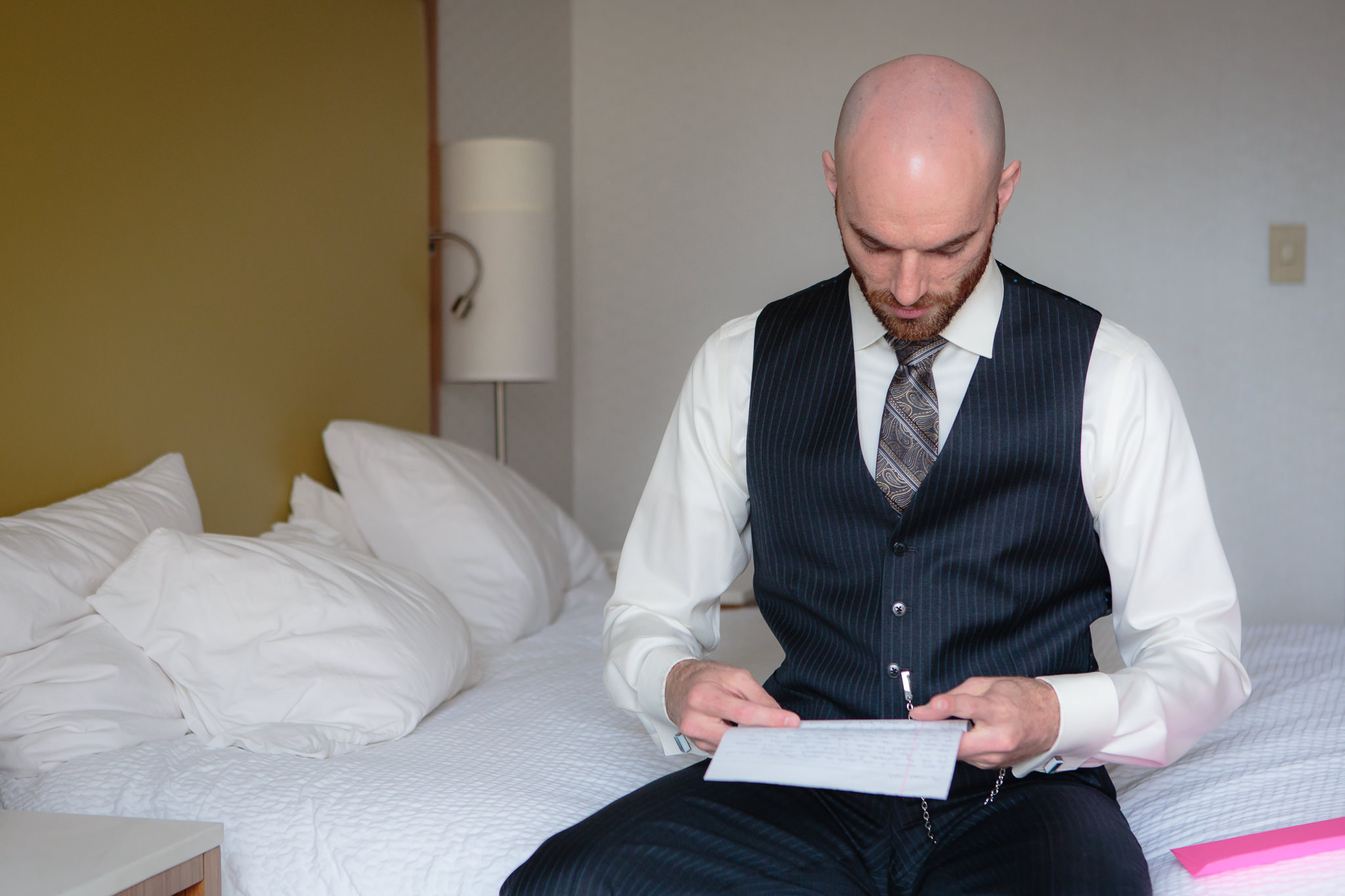 Groom reads a letter from his bride before his National Aviary wedding