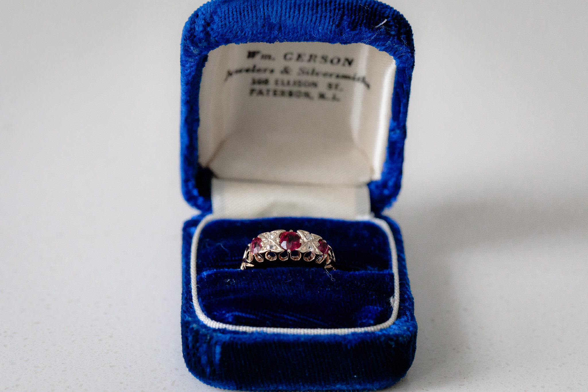 Bride's late mother's ring sits in a royal blue velvet ring box
