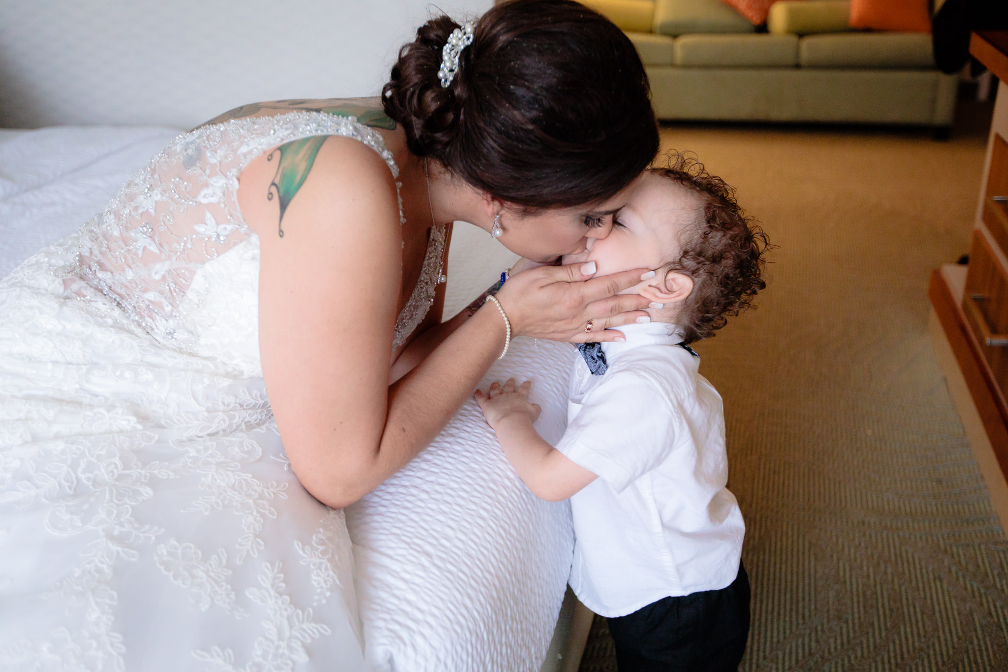Bride kisses her son, the ring bearer, before her National Aviary wedding