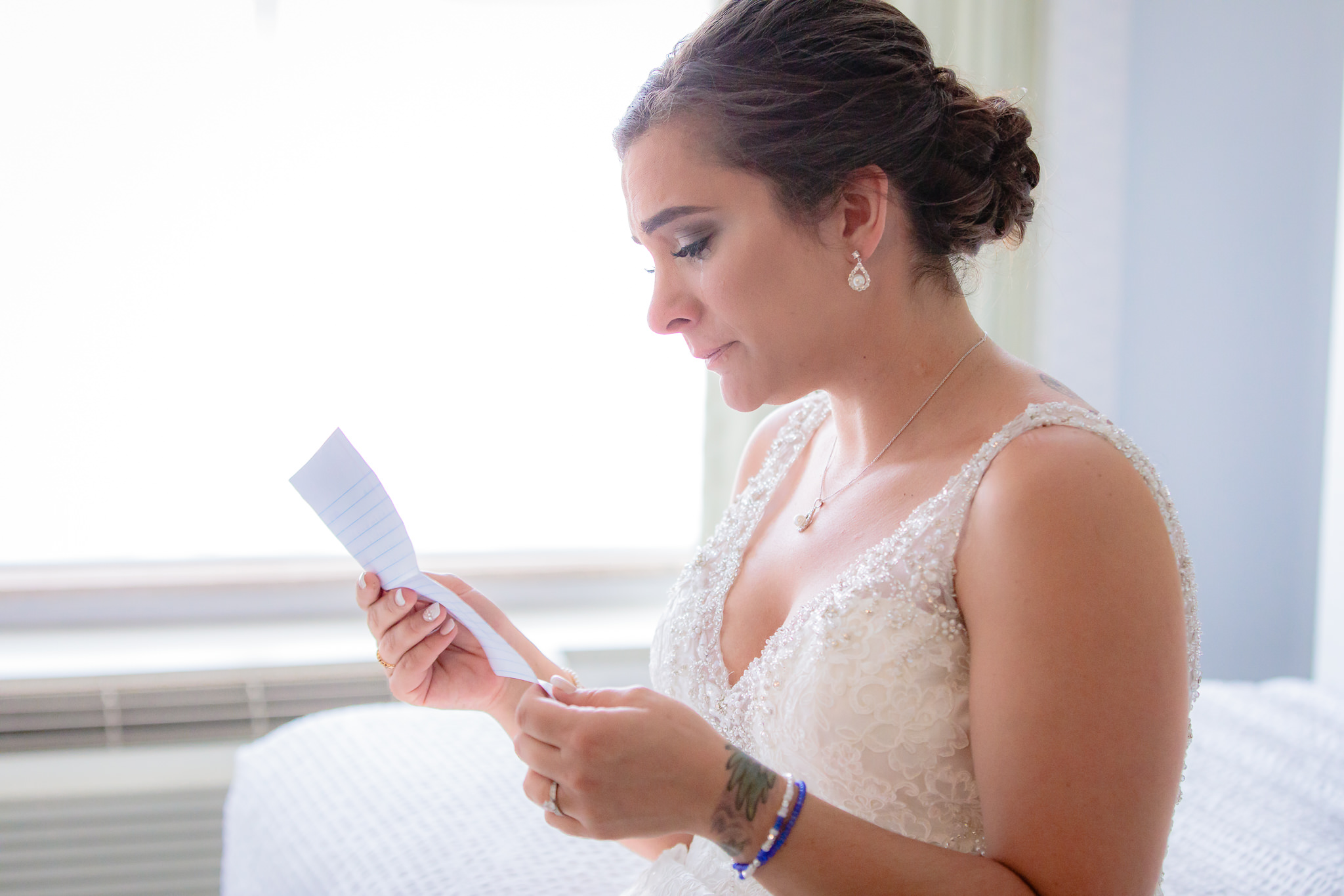 Bride reads a letter from the groom before her National Aviary wedding