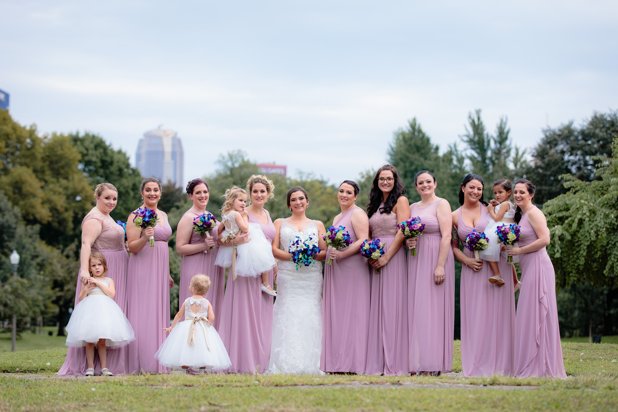 Bridesmaids pose for a photo in Allegheny Commons Park before a National Aviary wedding