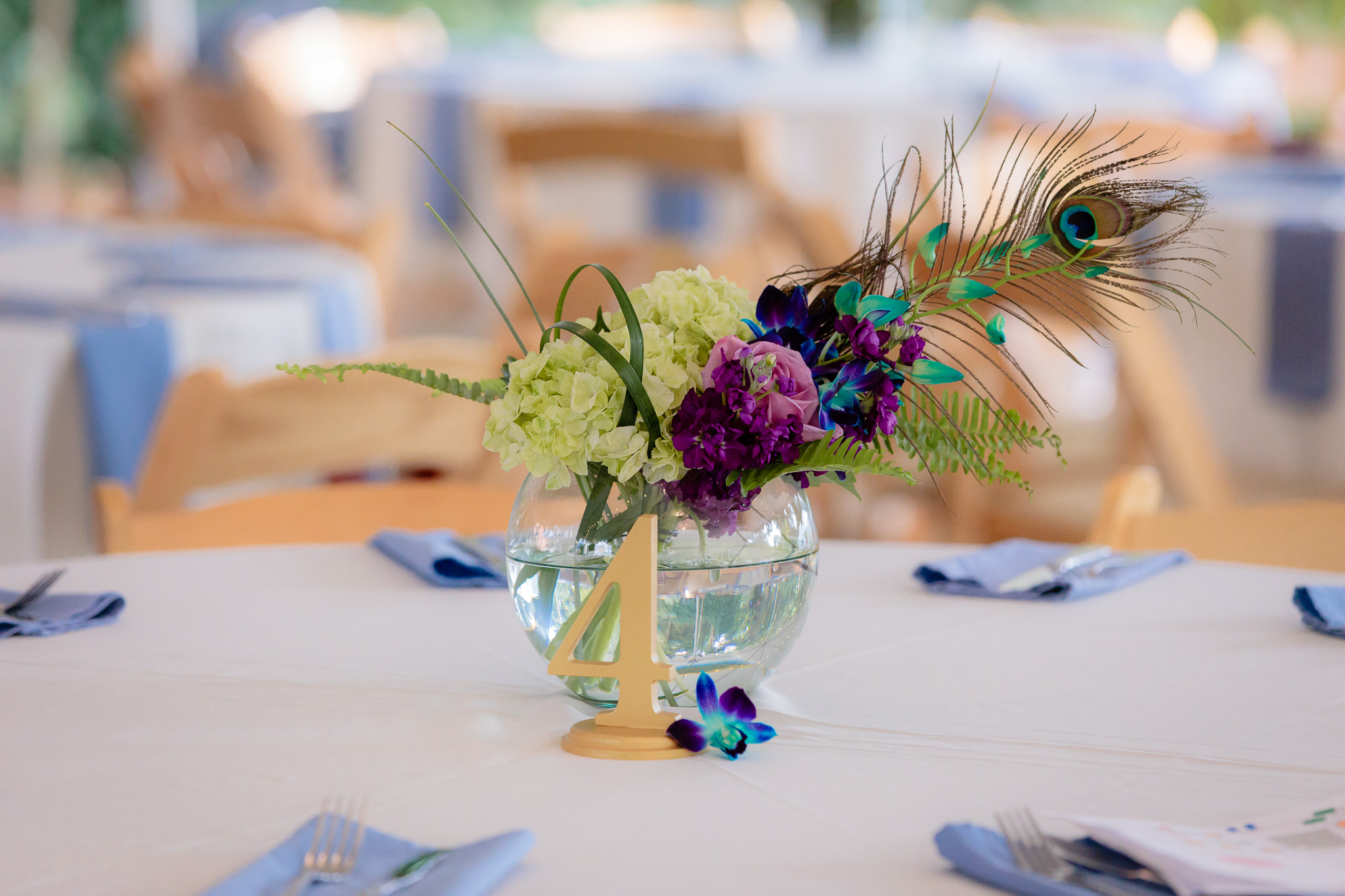 Floral & peacock centerpieces by One Happy Flower Shop at a National Aviary wedding