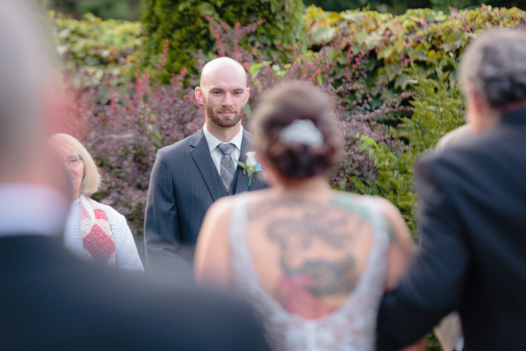 Groom waits for his bride to walk down the aisle at a National Aviary wedding