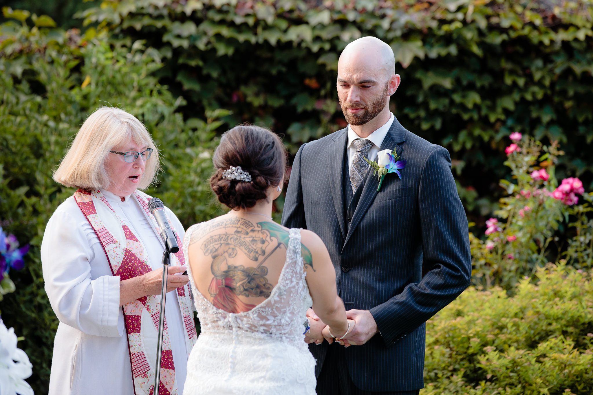 Groom listens to the bride say her vows at a National Aviary wedding ceremony
