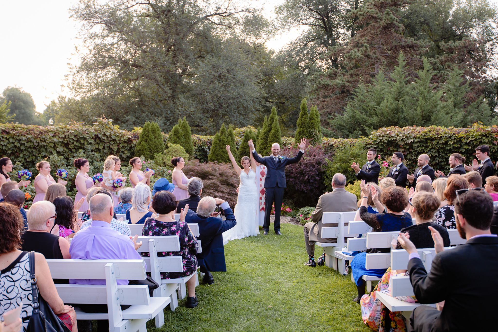 Newlyweds are pronounced husband and wife at an outdoor National Aviary wedding ceremony