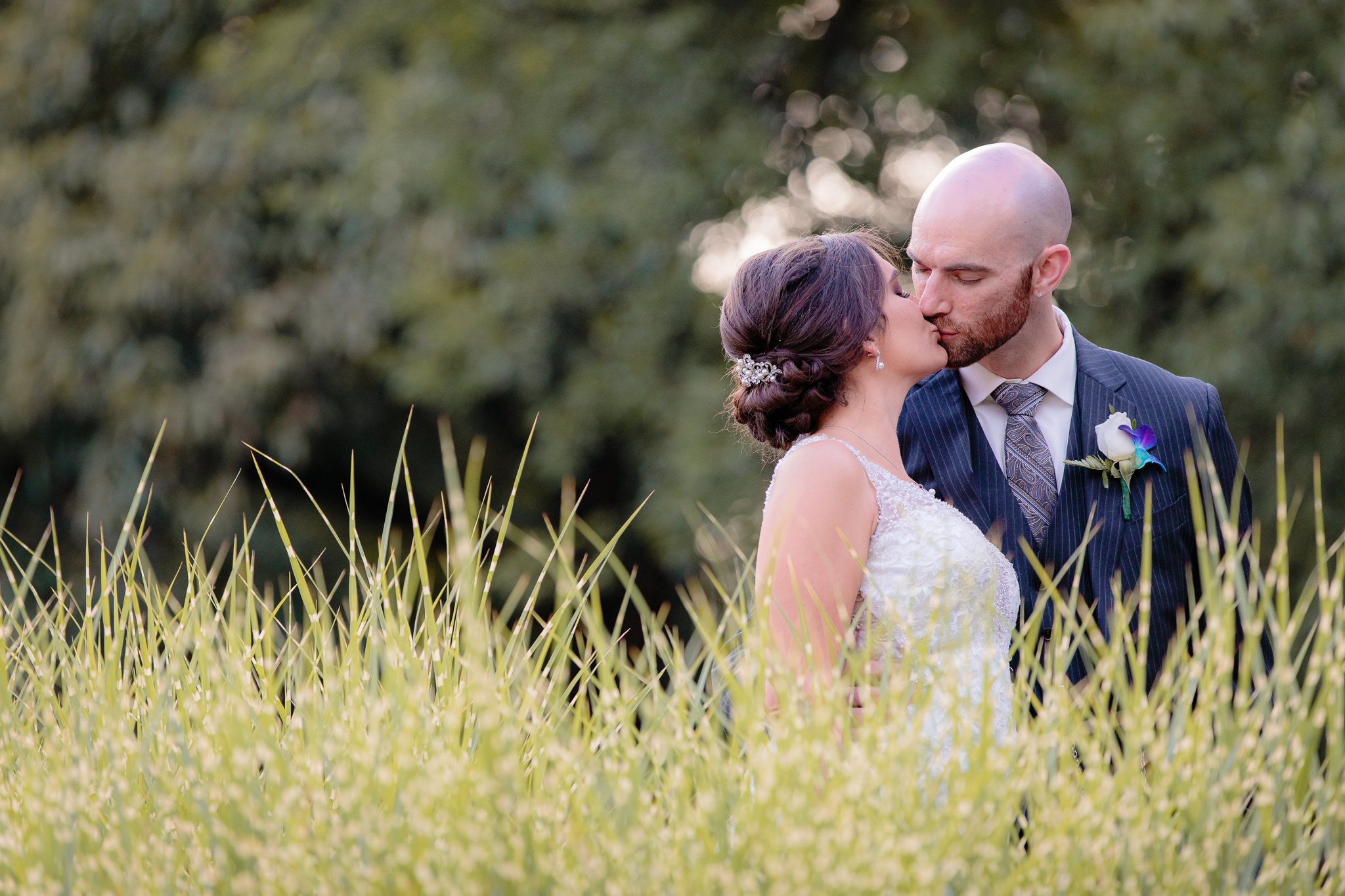 Newlyweds share a kiss during portraits at the National Aviary