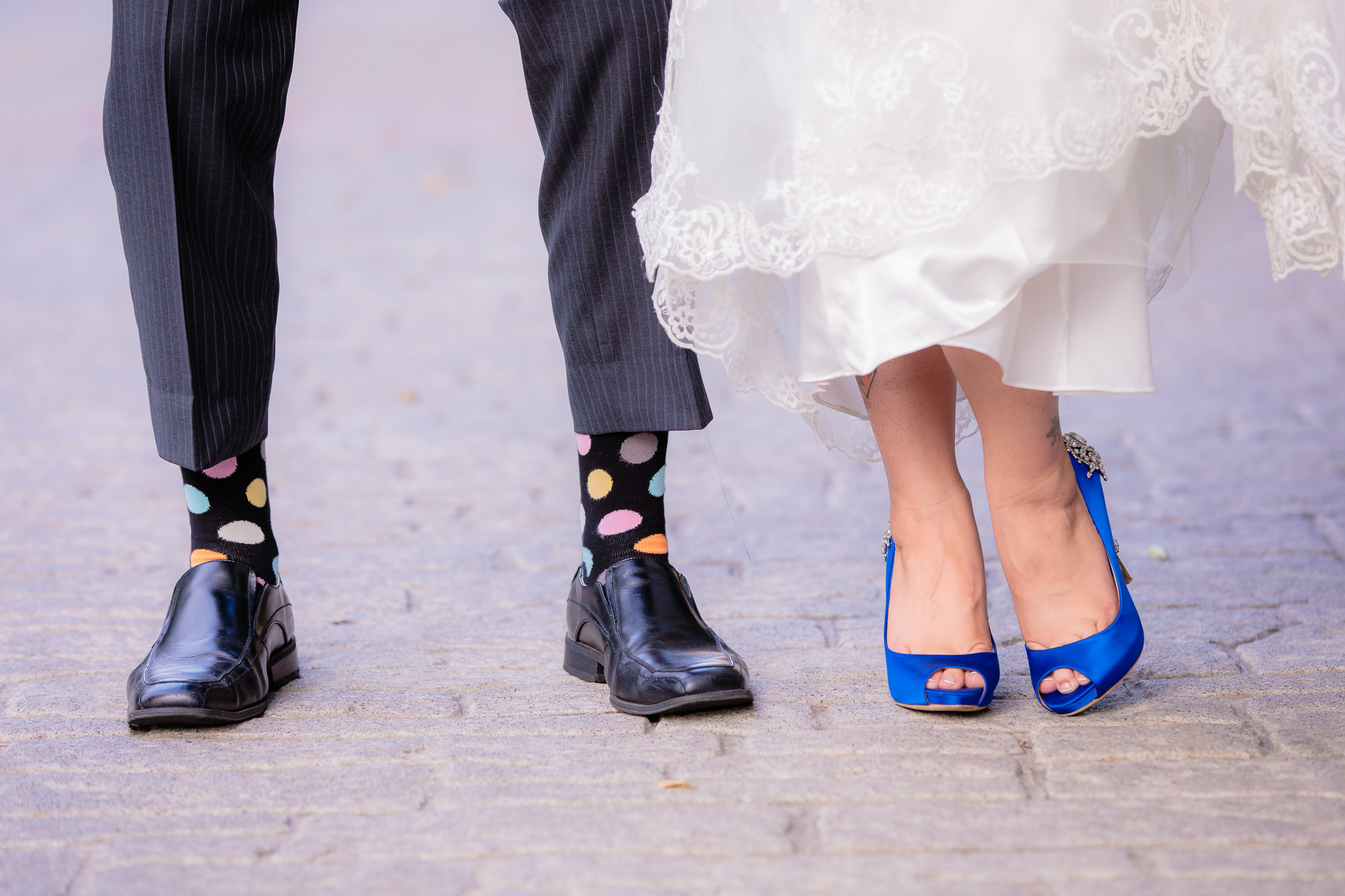 Groom's polkadot socks and bride's royal blue Badgley Mischka shoes