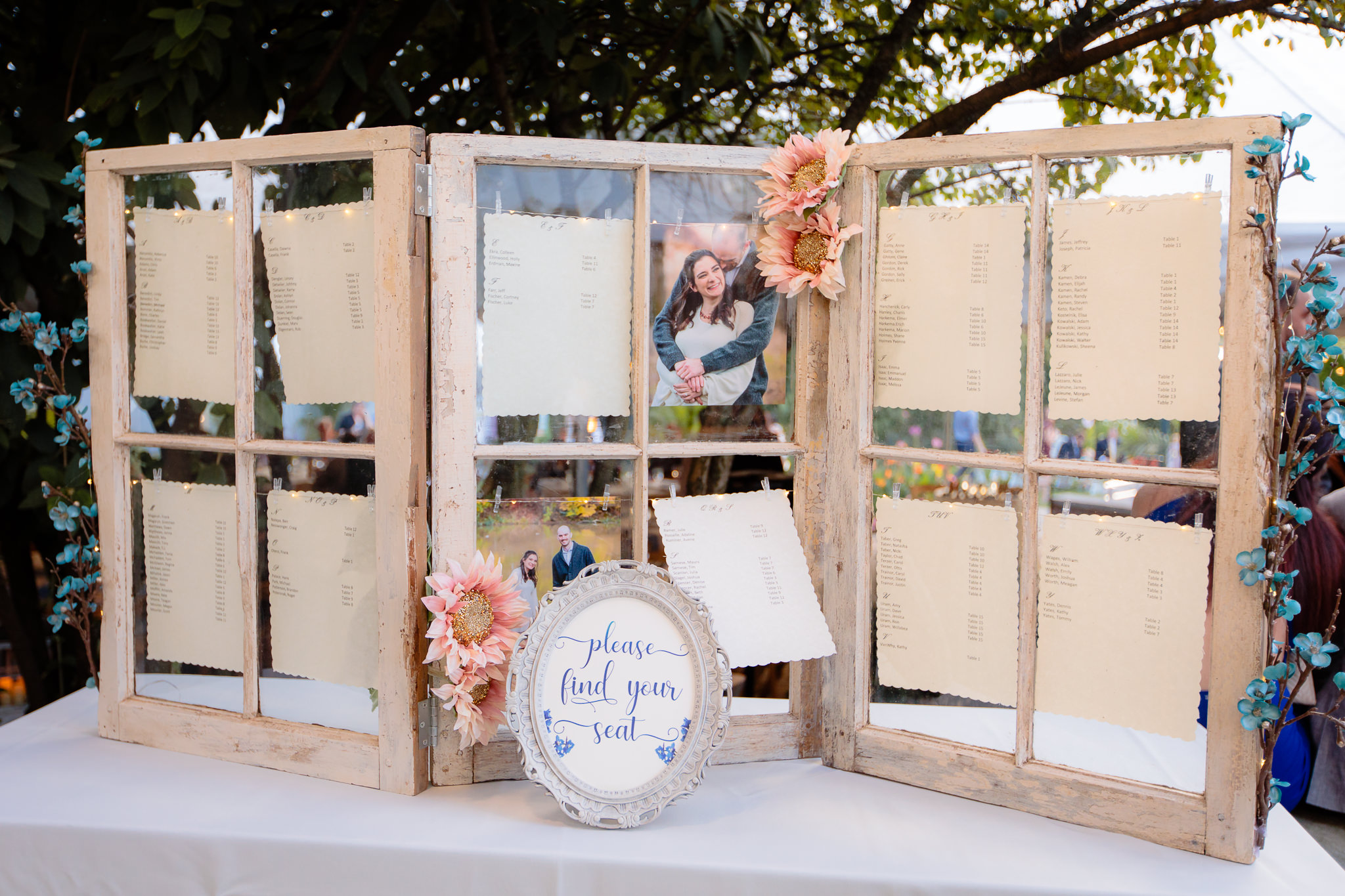 Seating chart on weathered glass window panes at a National Aviary wedding
