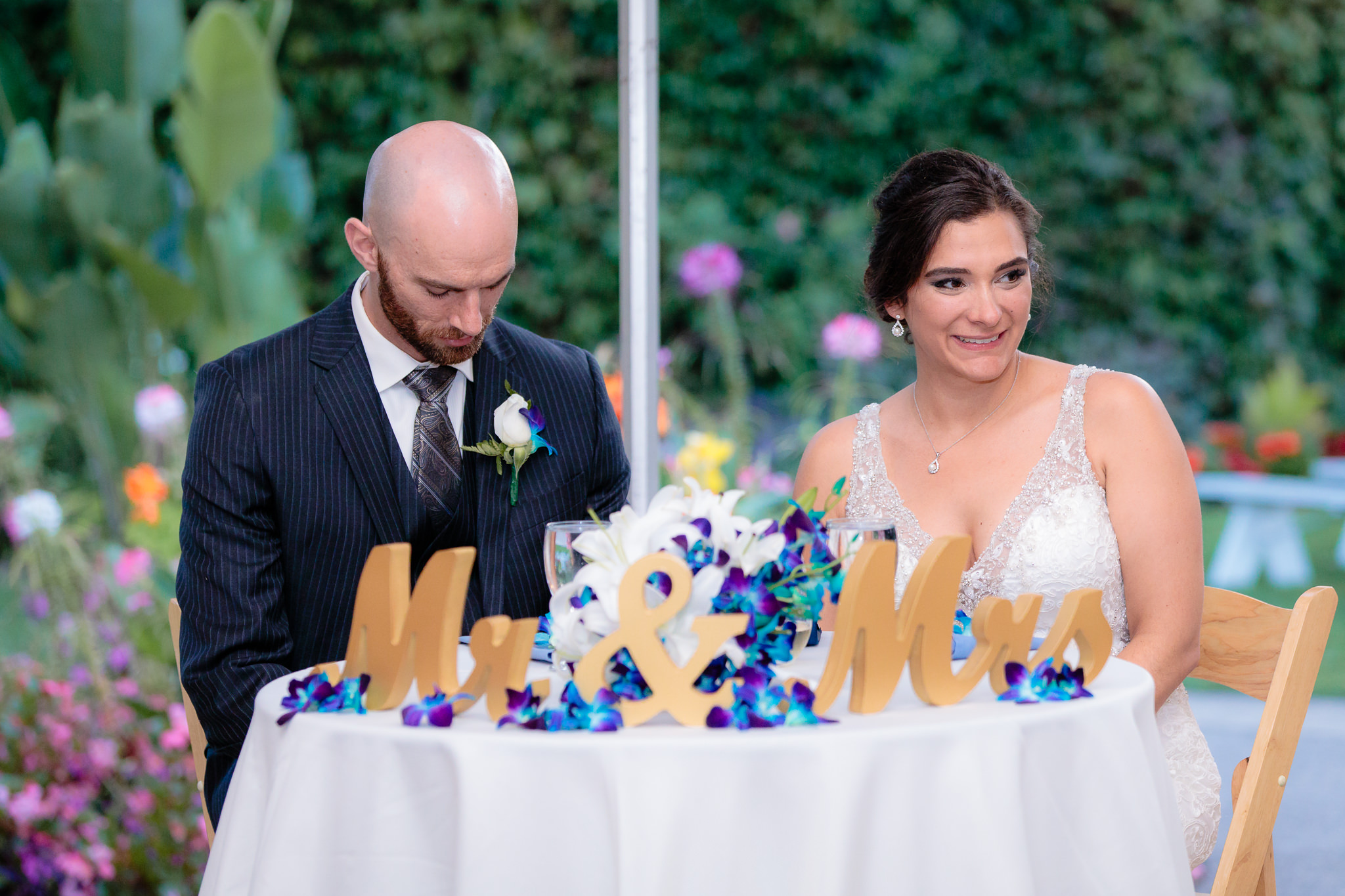 Newlyweds listen to speeches during their National Aviary wedding reception