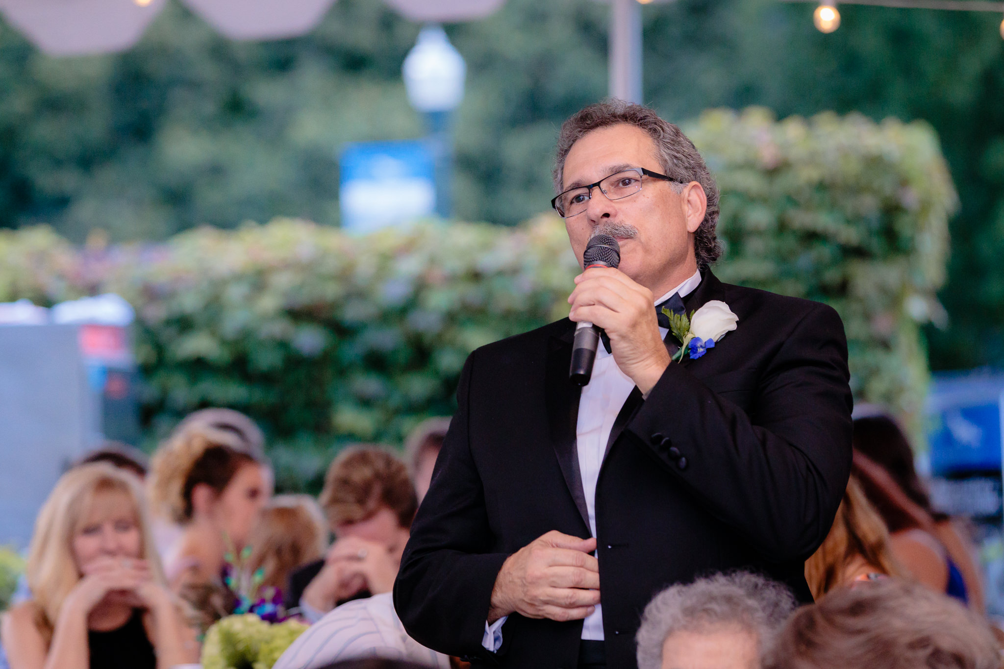 Father of the bride gives a blessing at a National Aviary wedding reception