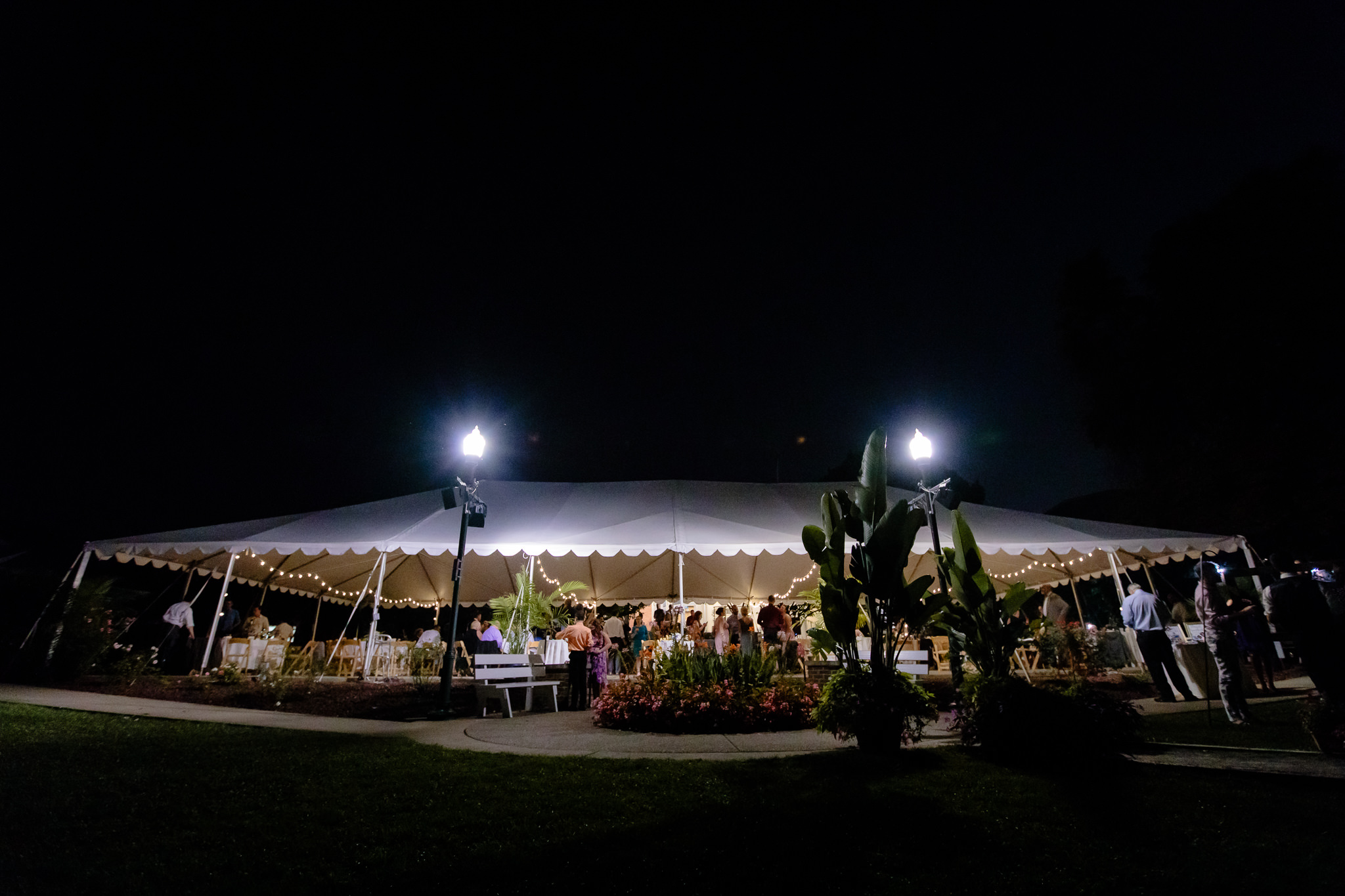 Outdoor tented wedding reception at night at the National Aviary in Pittsburgh, PA