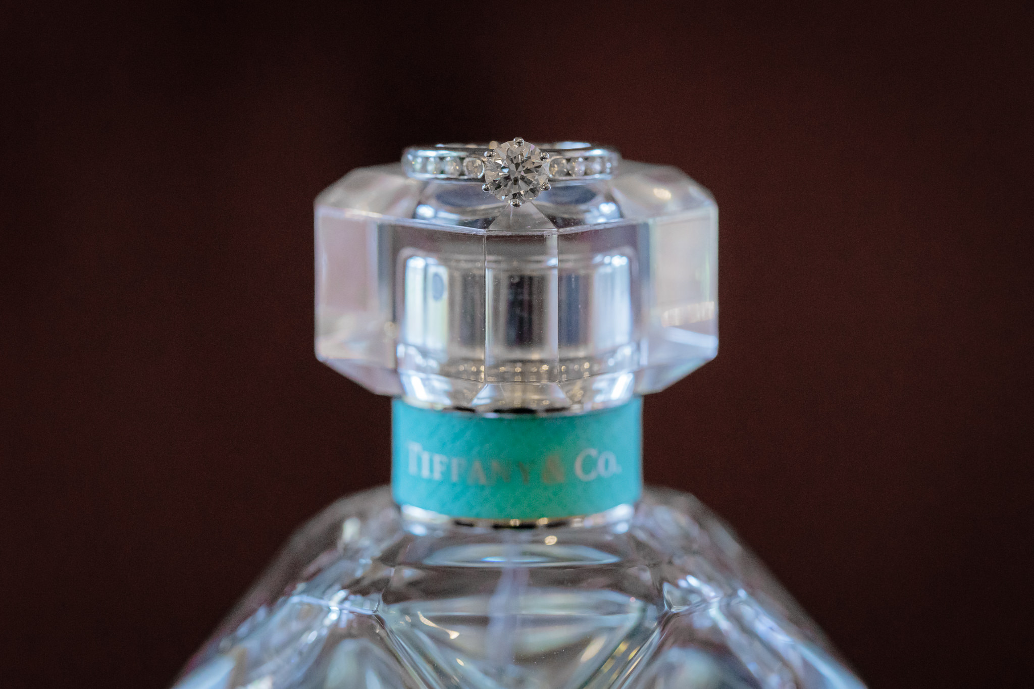 Tiffany engagement ring rests on top of glass Tiffany perfume bottle at Oglebay