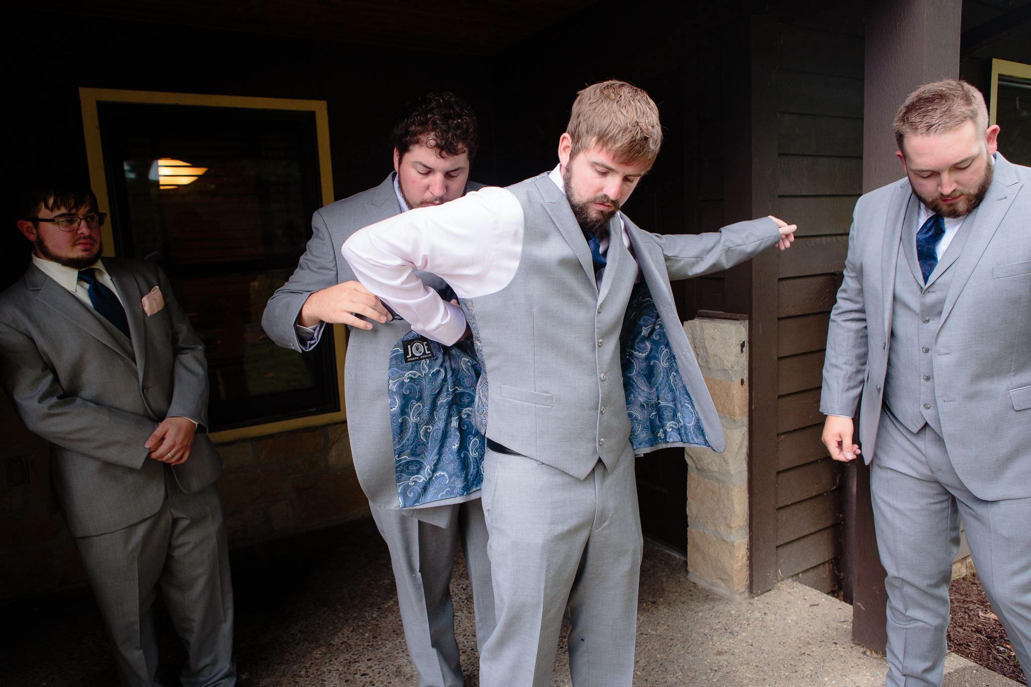 Best man helps the groom into his tux before his Oglebay wedding ceremony