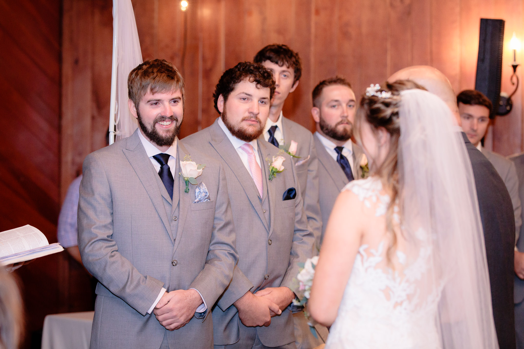 Groom smiles at his bride as she reaches the altar at an Oglebay wedding