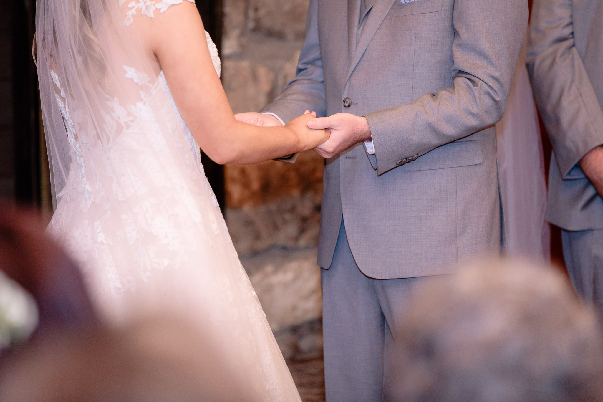 Bride and groom hold hands during their Oglebay wedding ceremony