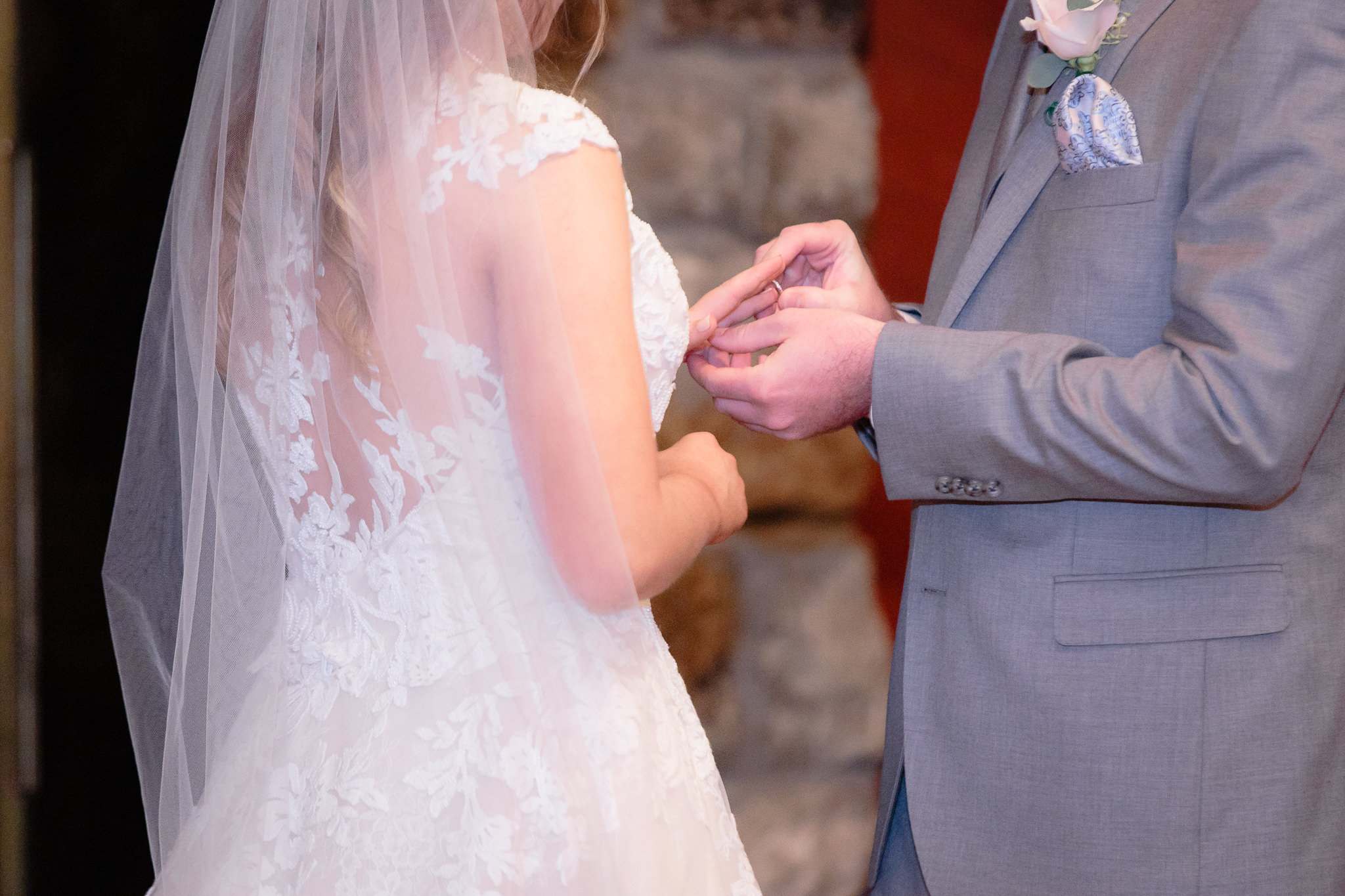 Groom places the wedding band on his bride's finger during their Oglebay wedding