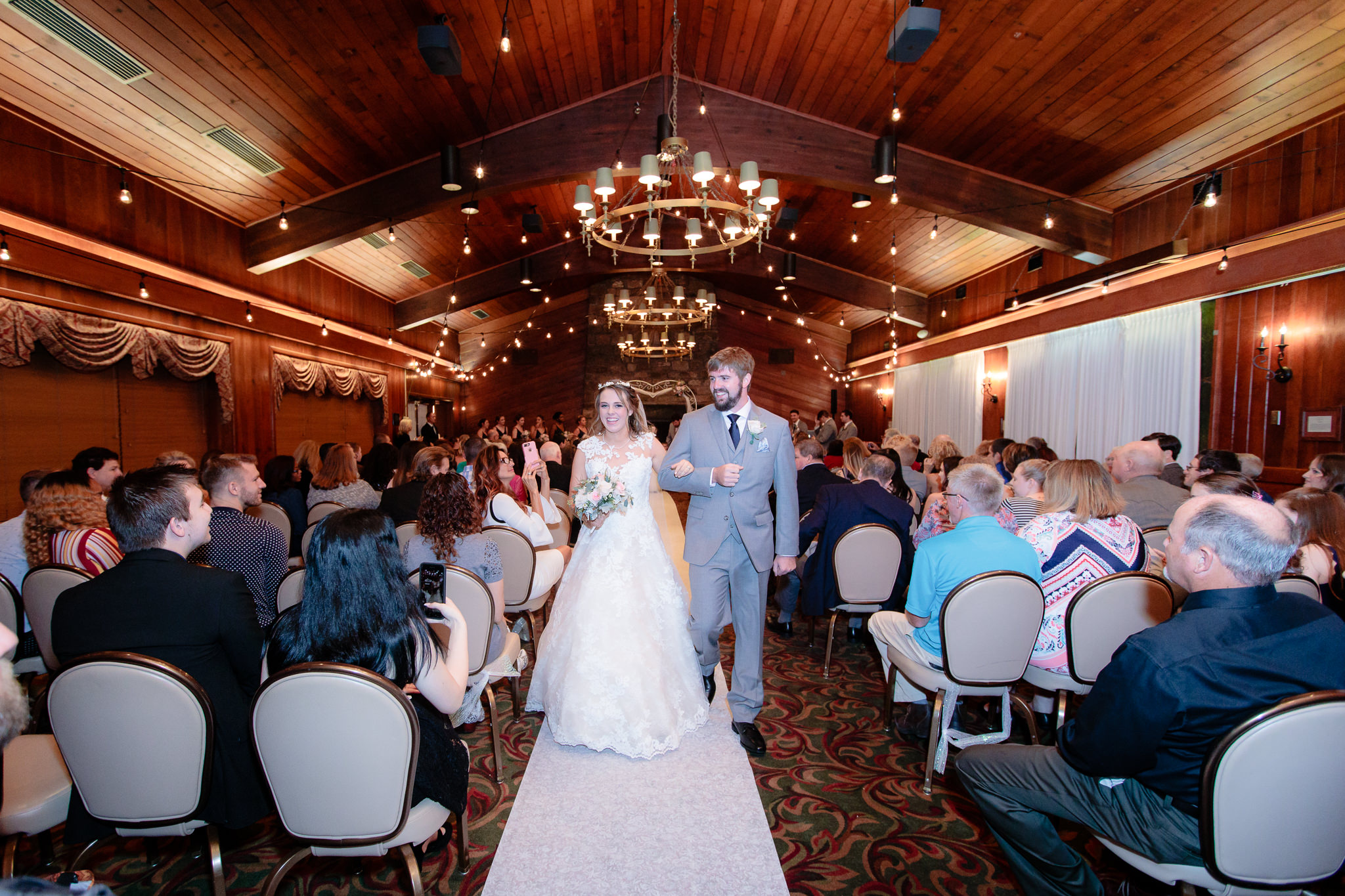 Newlyweds exit their wedding ceremony inside Wilson Lodge at Oglebay