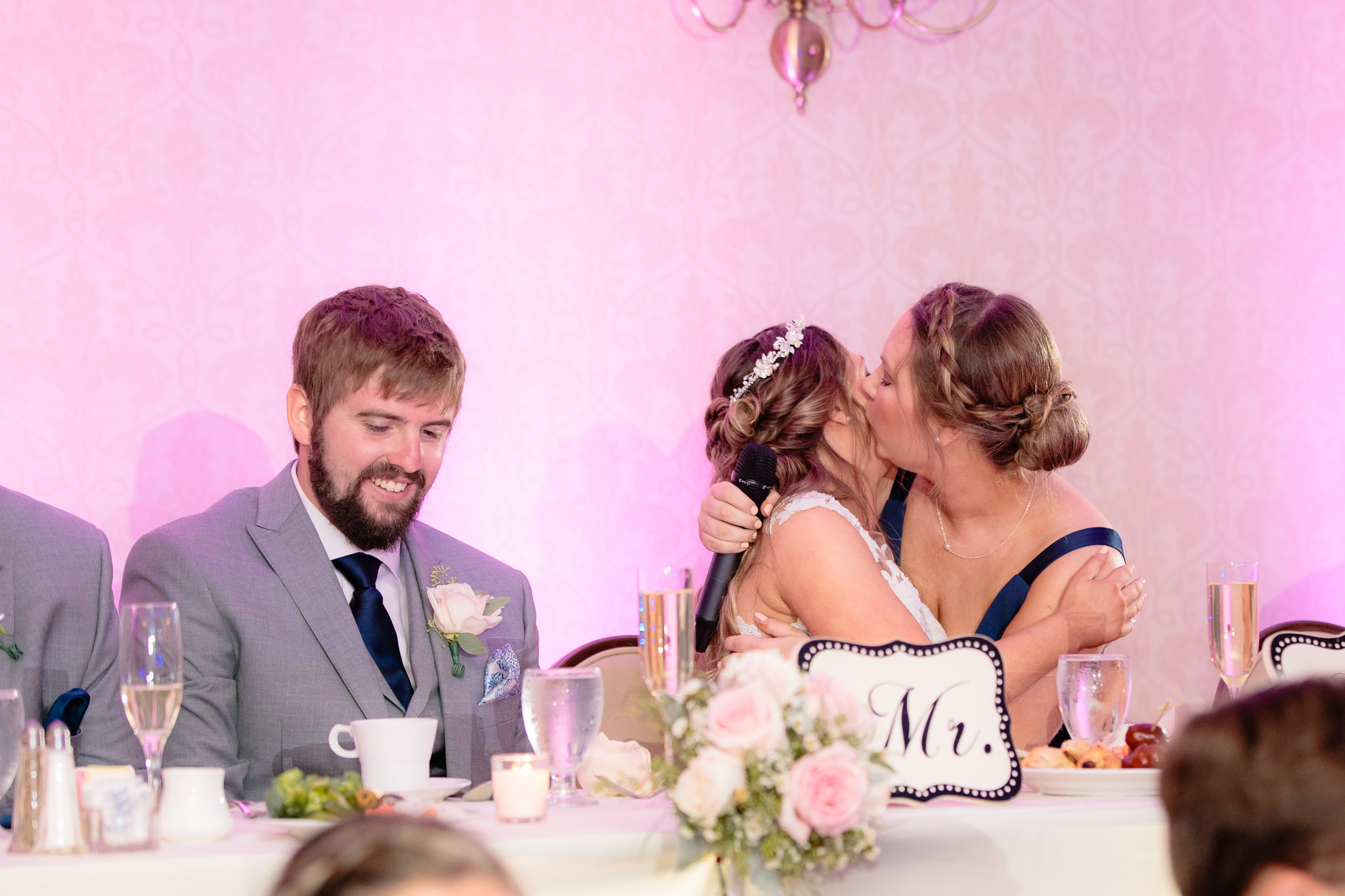 Maid of honor hugs the bride at an Oglebay wedding