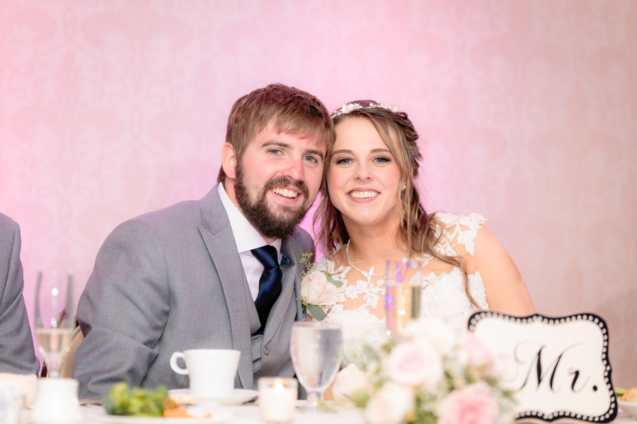 Bride & groom smile from the head table at their Oglebay wedding