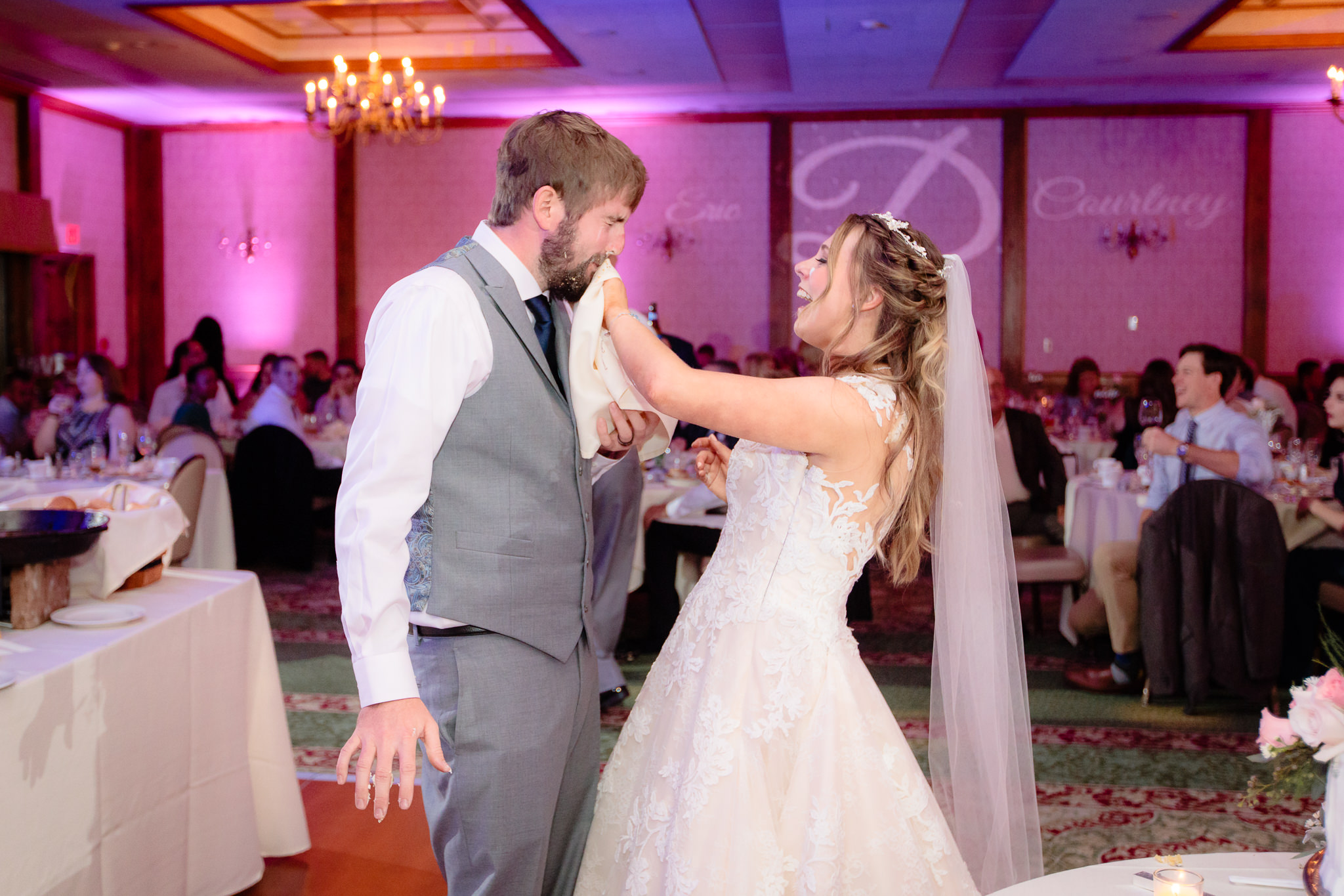 Bride wipes icing off of groom's face at an Oglebay wedding