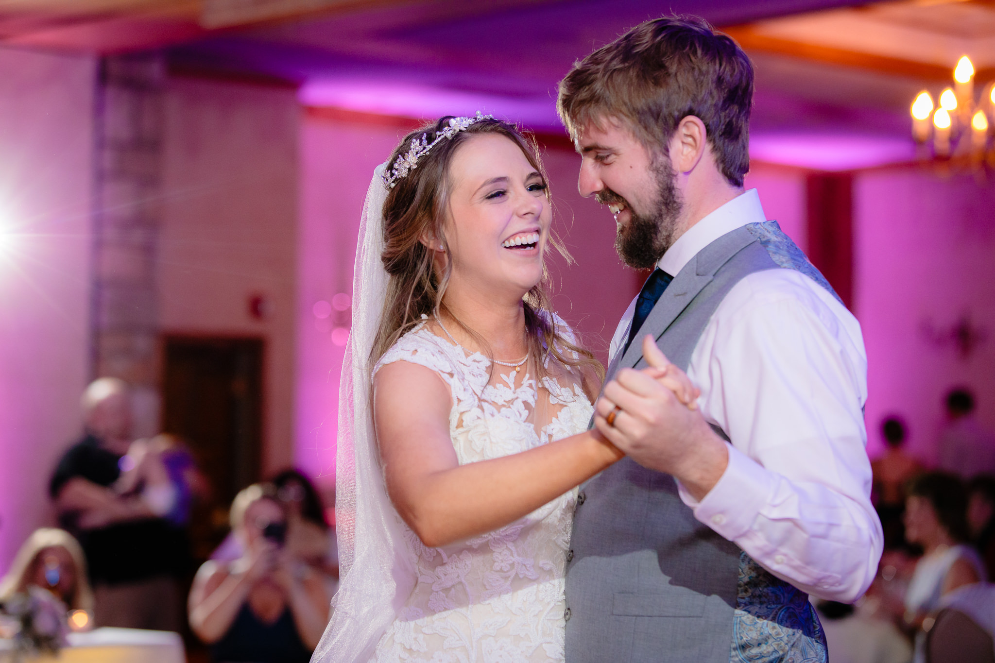 Newlyweds laugh together during their first dance at Oglebay