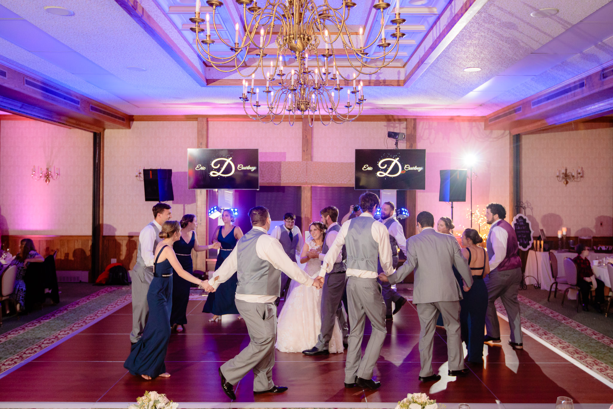 Bridal party circles the bride & groom on the dance floor at Oglebay