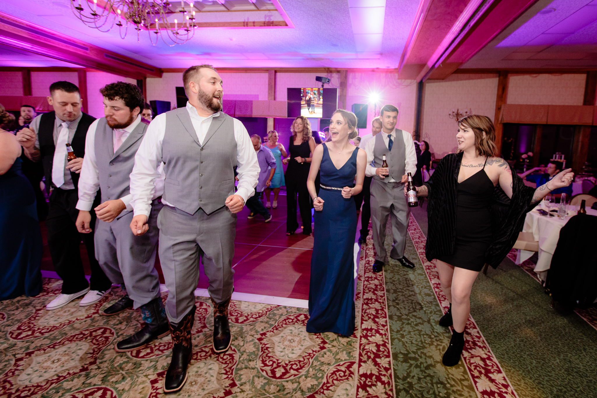 Guests do a line dance at an Oglebay wedding reception