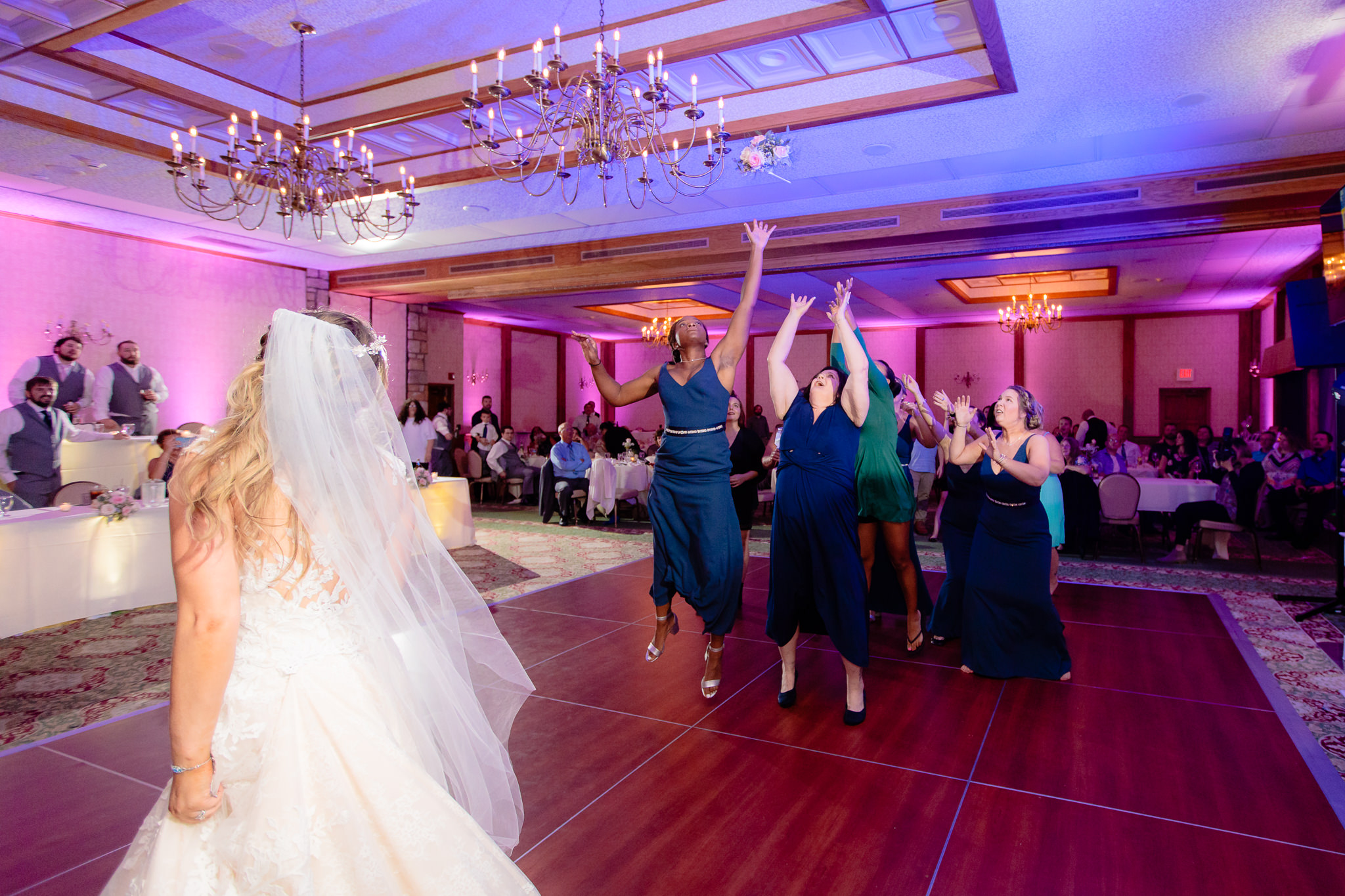 Single ladies jump for the bouquet at an Oglebay wedding