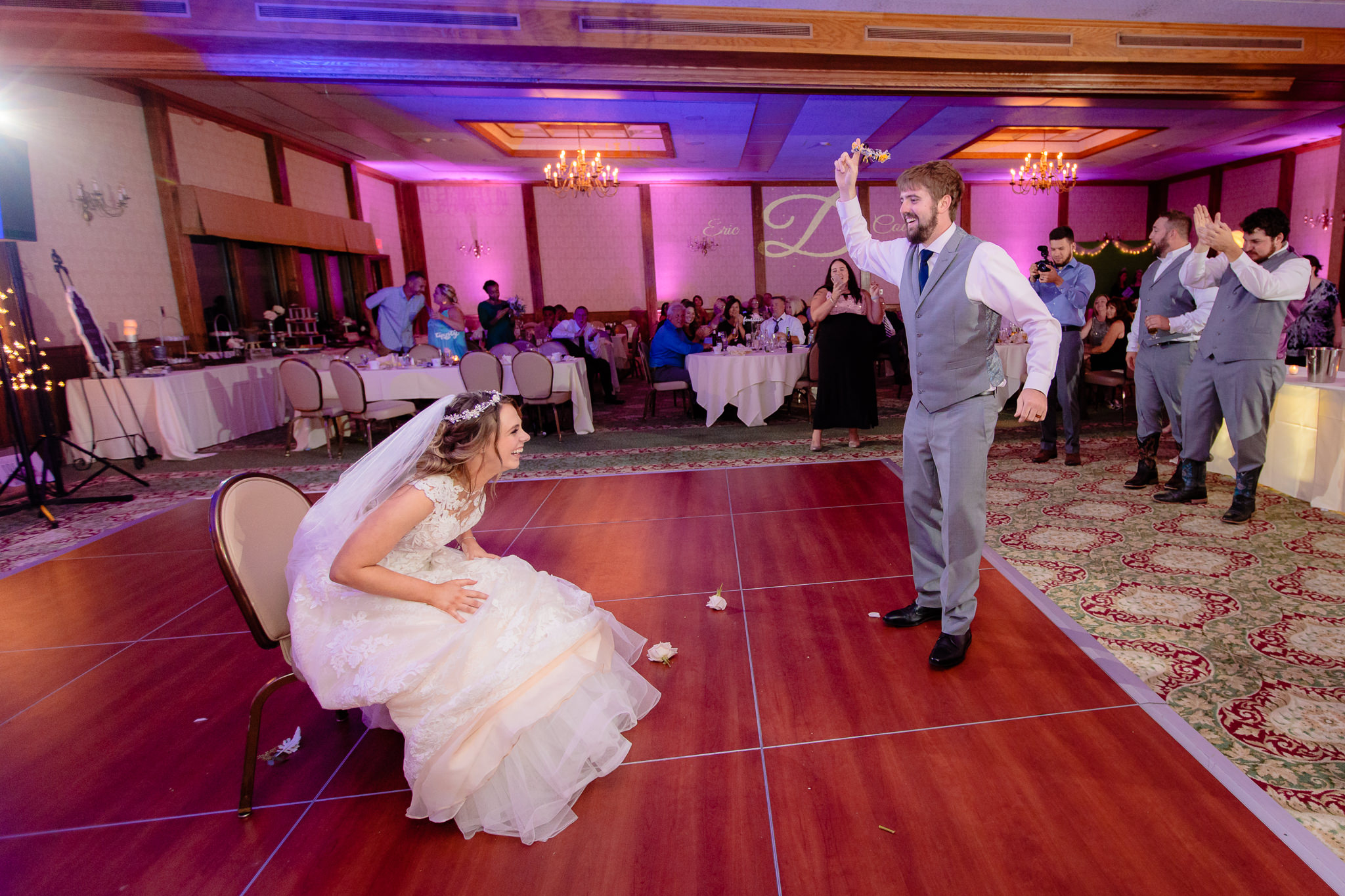 Groom waves the garter in the air at his Oglebay wedding