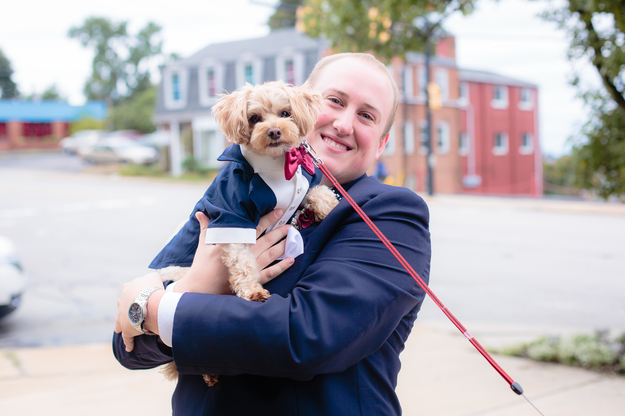 The groom and his dog in matching suits outside a wedding at the Pennsylvanian