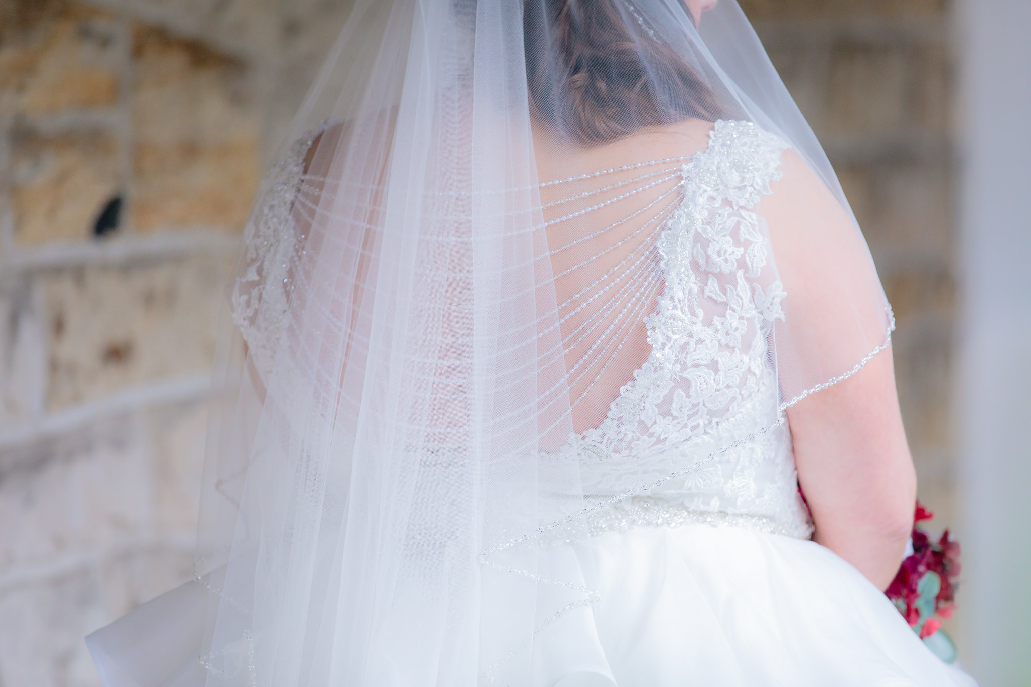 Beaded detailing across the back of the bride's dress along with lace straps at Mt. Lebanon United Methodist Church
