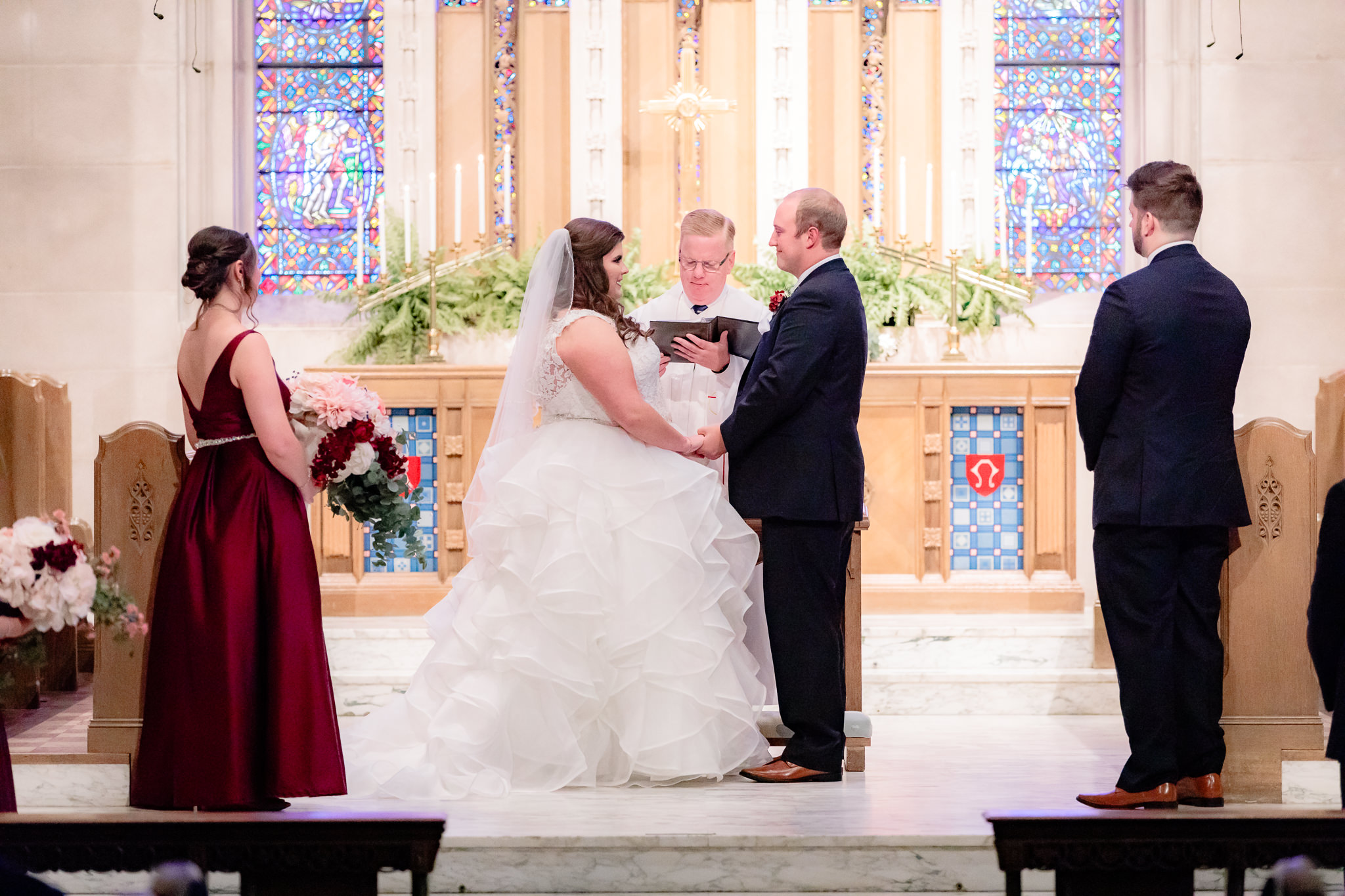 The bride and groom hold hands as they recite their vows at Mt. Lebanon United Methodist Church