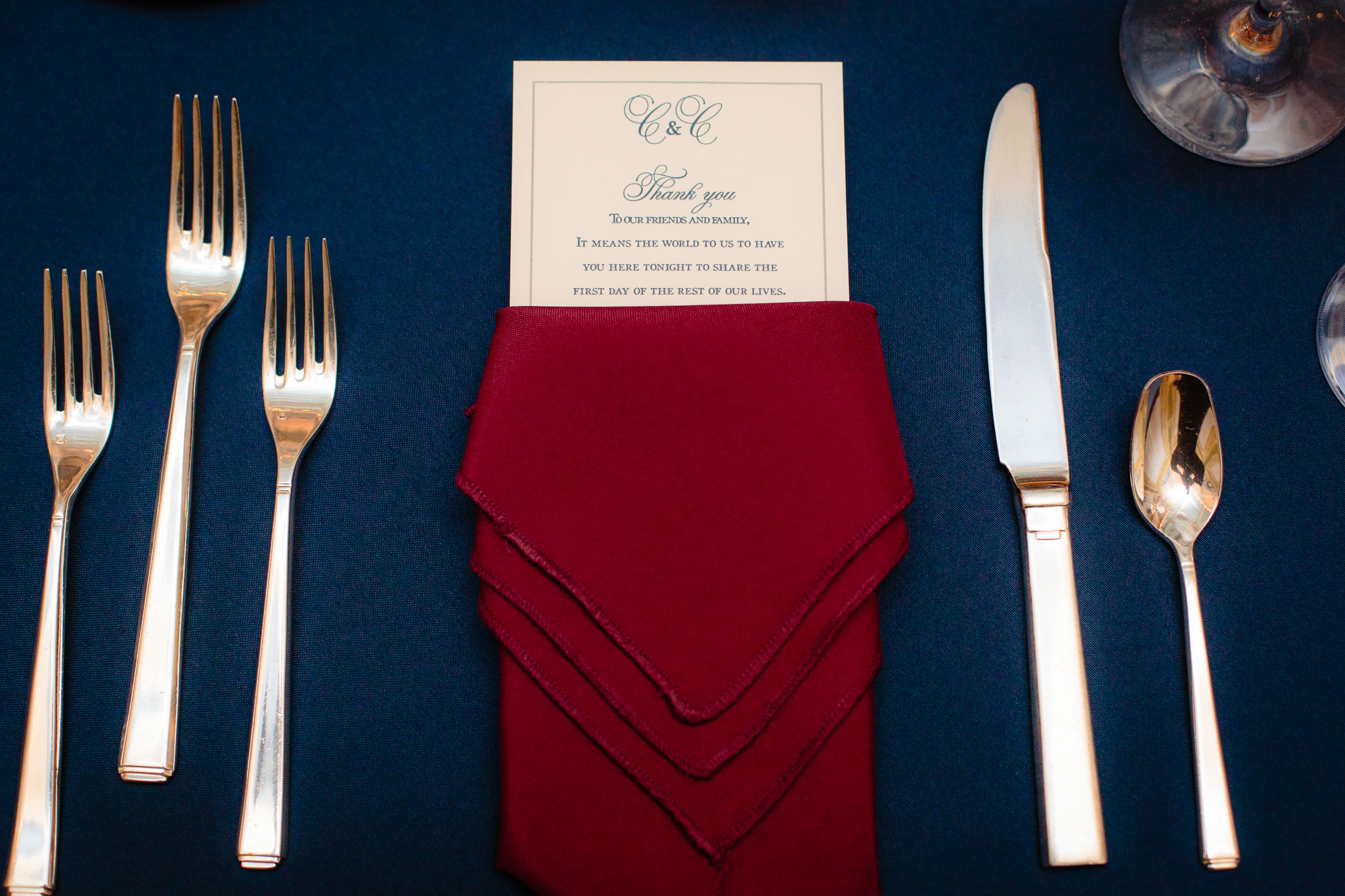 A red napkin and gold silverware frame the place card at the Pennsylvanian