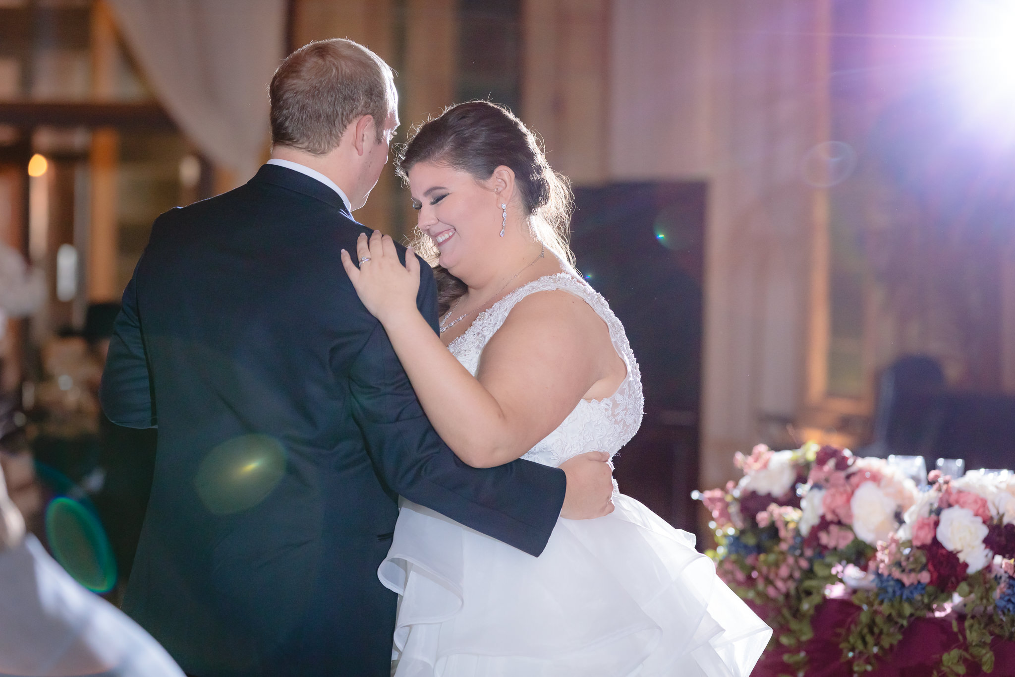 A smiling bride during the couple's first dance at the Pennsylvanian