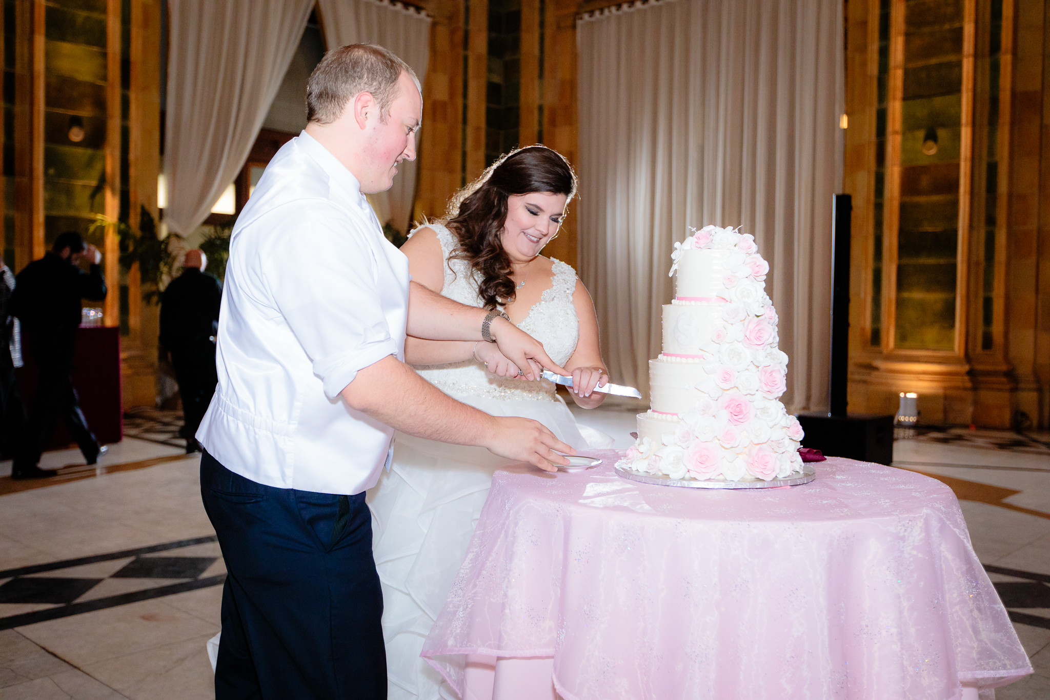 Bride and groom cut their wedding cake done by Rania's Catering at the Pennsylvanian
