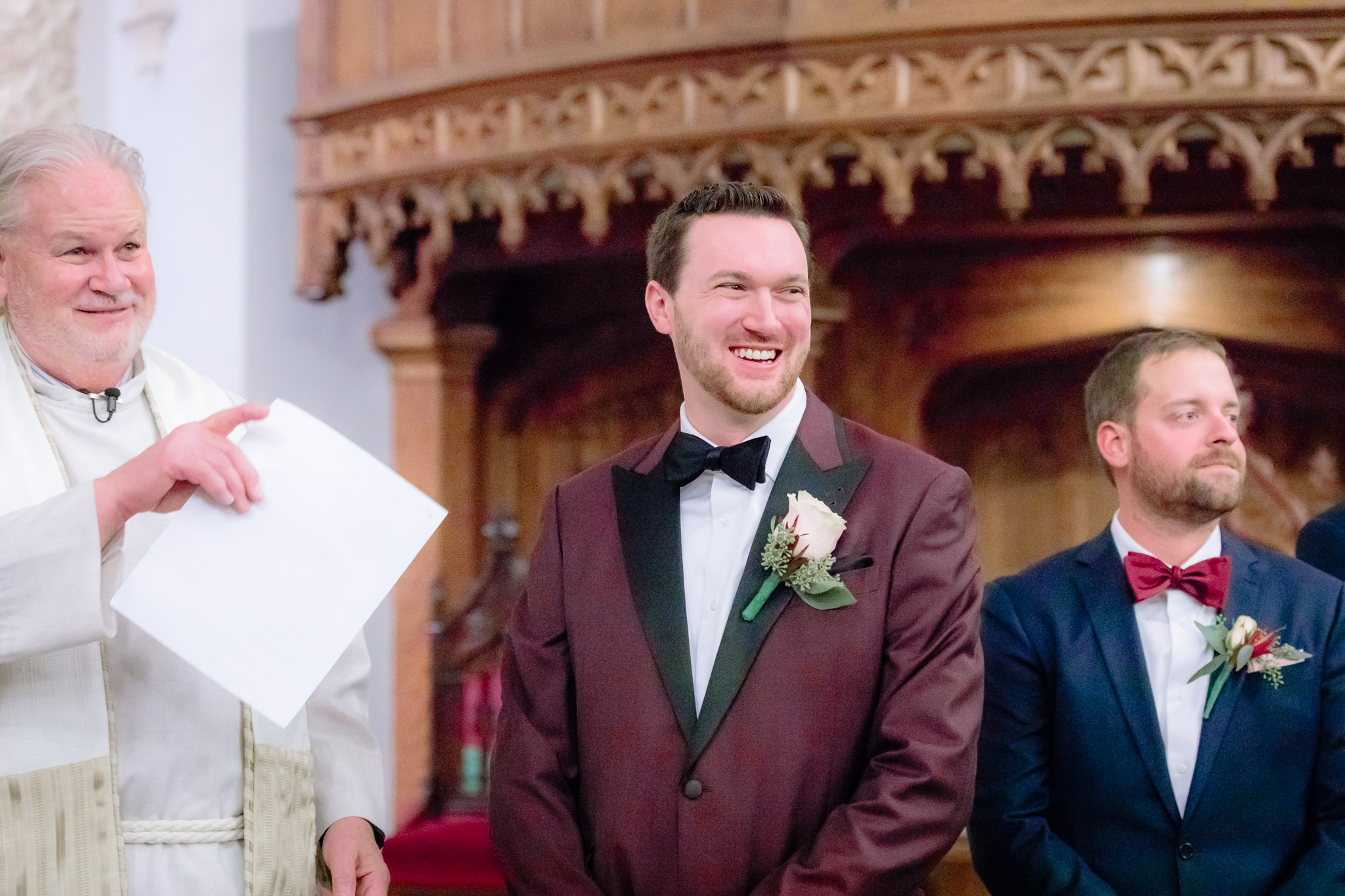 Groom laughs on the altar of the Smithfield United Church of Christ as his wedding begins