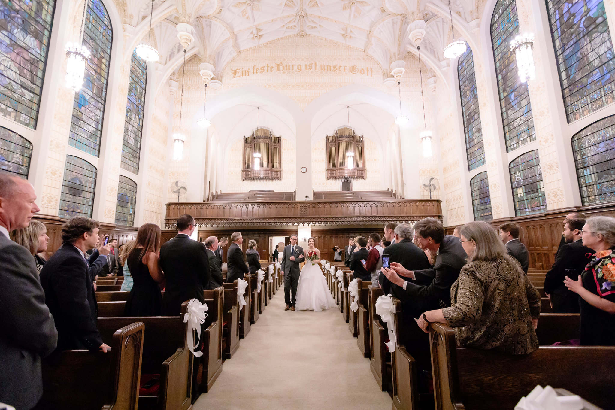 Bride walks down the aisle of Smithfield United Church of Christ with her father