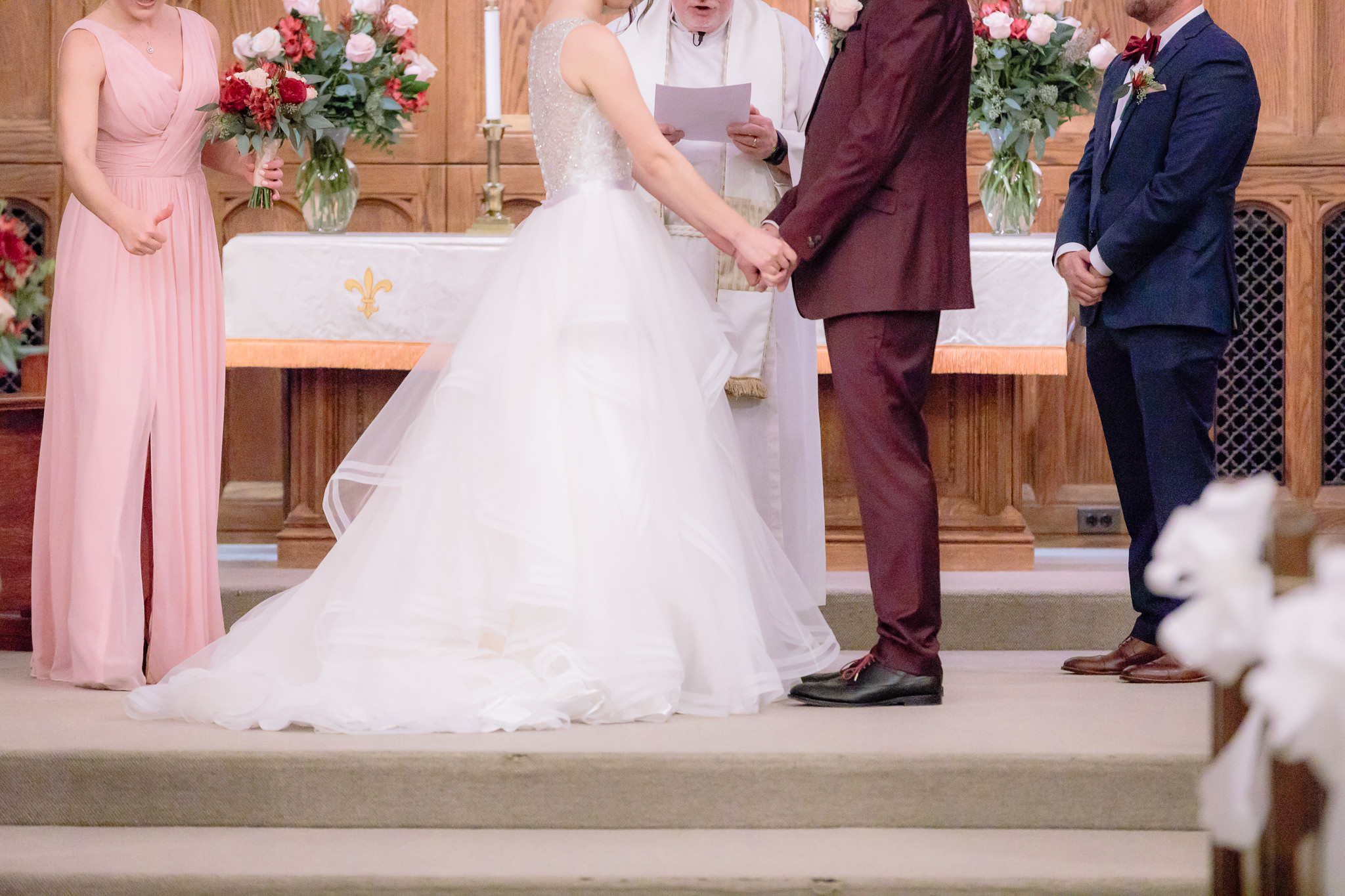 Bride & groom hold hands during their Smithfield United Church of Christ wedding ceremony