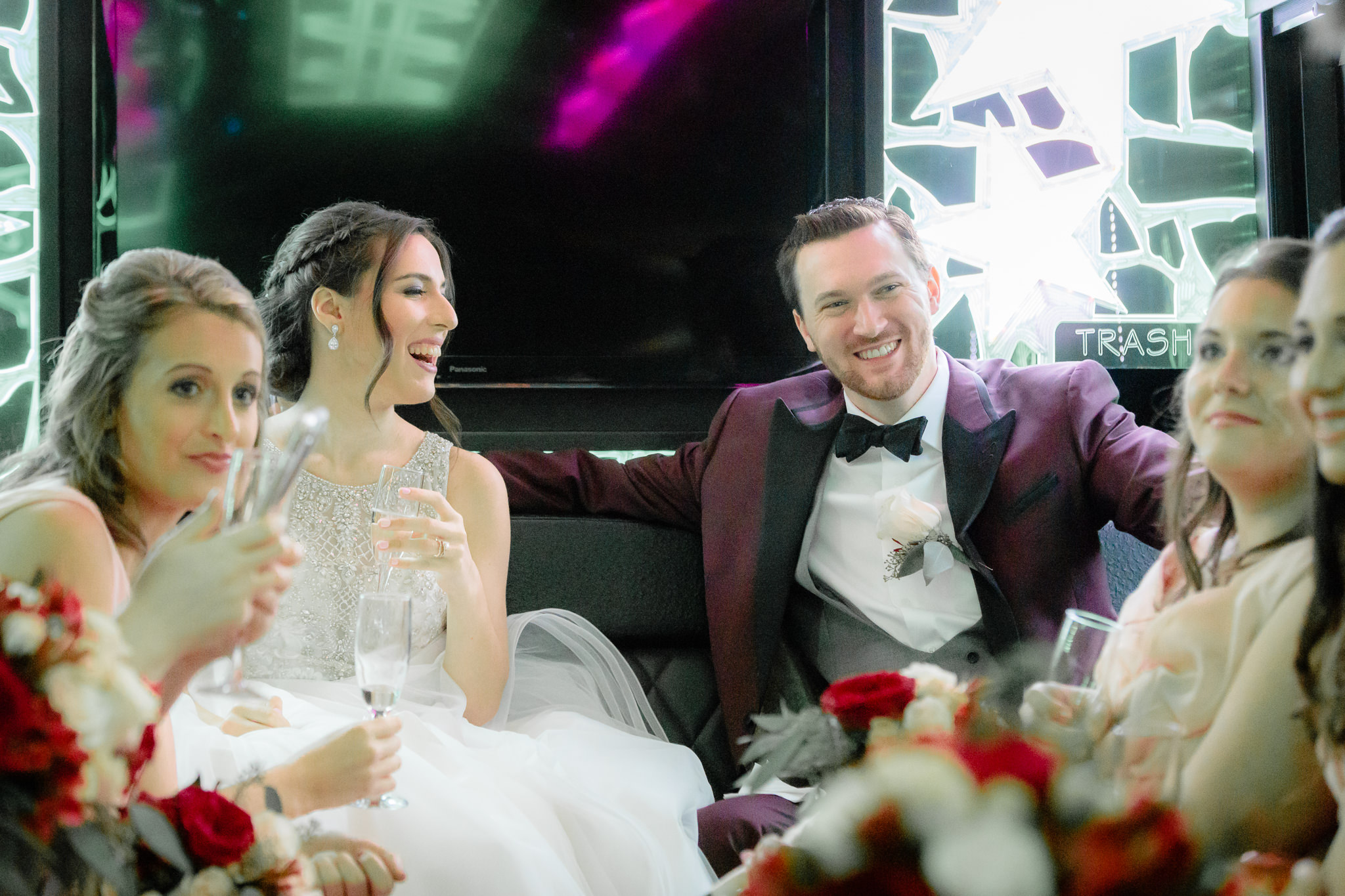 Bride & groom laugh during a limo ride through downtown Pittsburgh