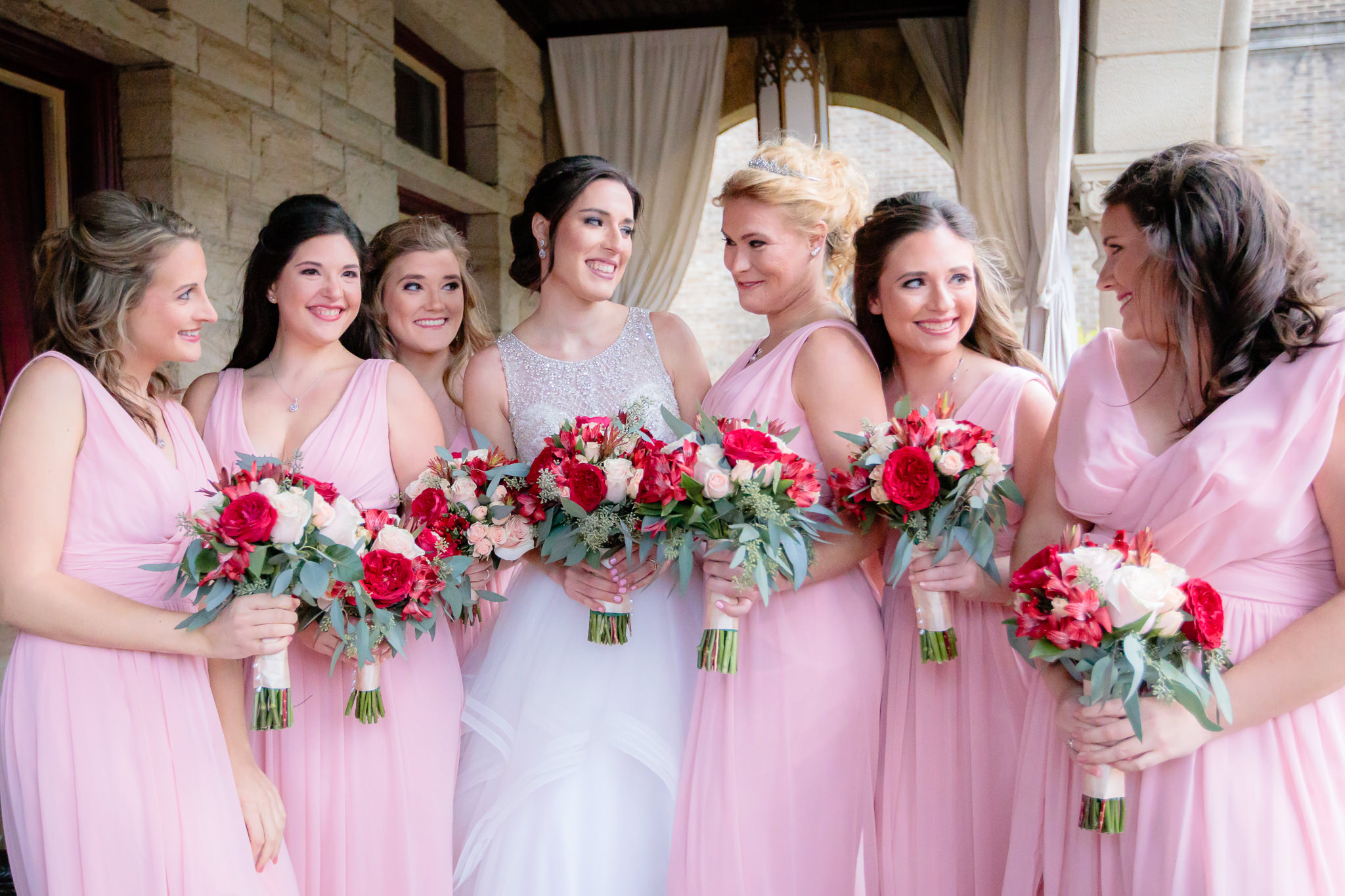 Bridesmaids laugh with the bride before a LeMont wedding