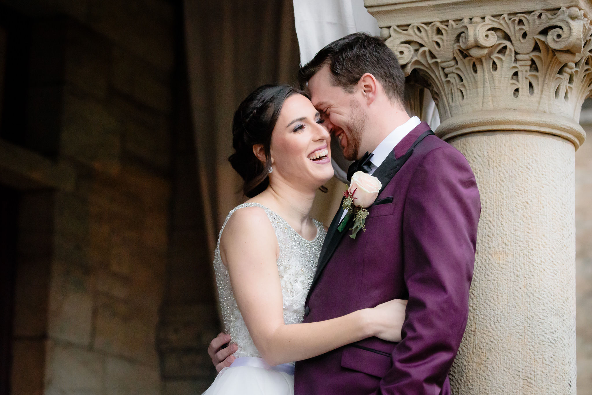 Bride and groom snuggle together and laugh during portraits on the North Side of Pittsburgh