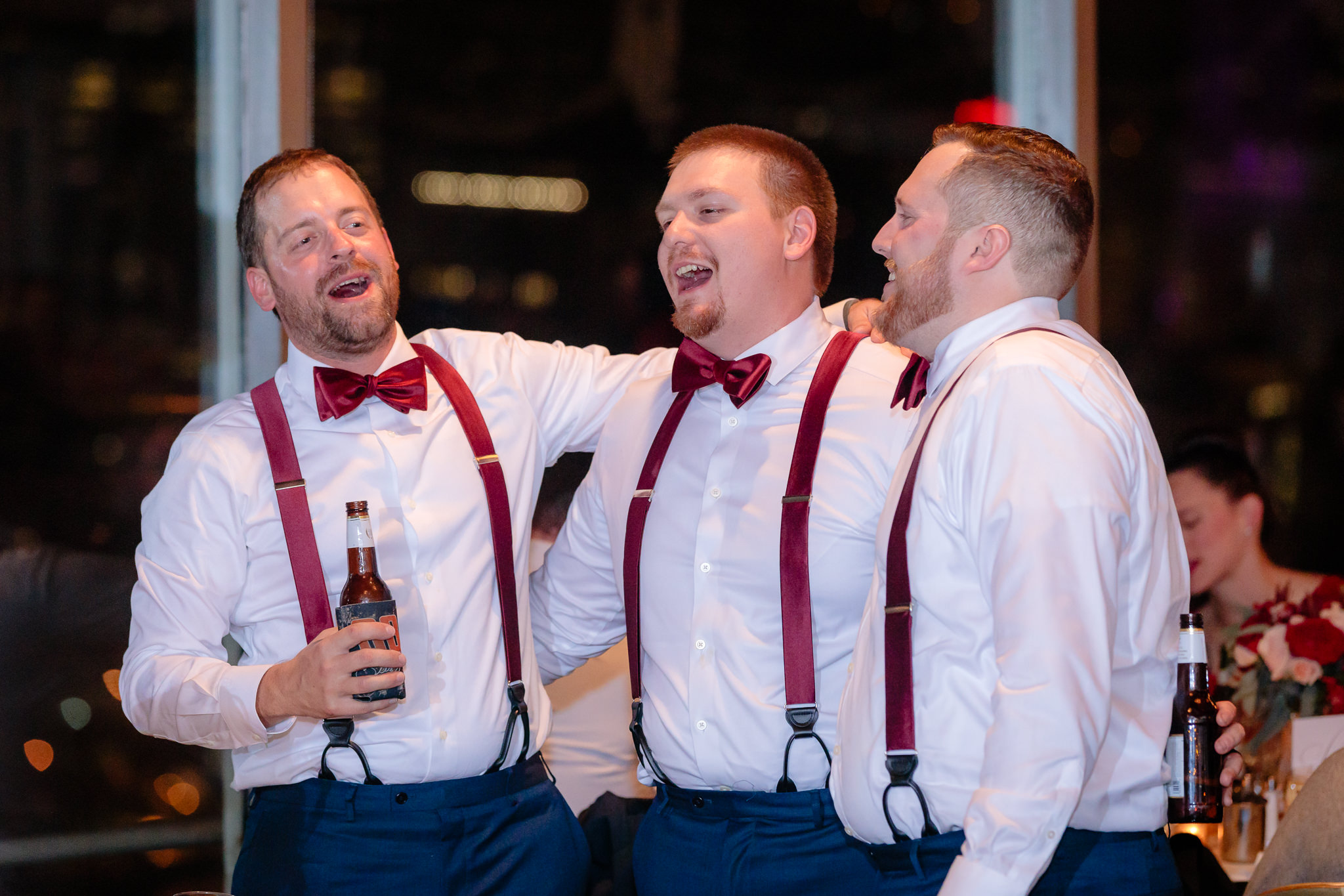 Groomsmen sing together at a LeMont wedding reception