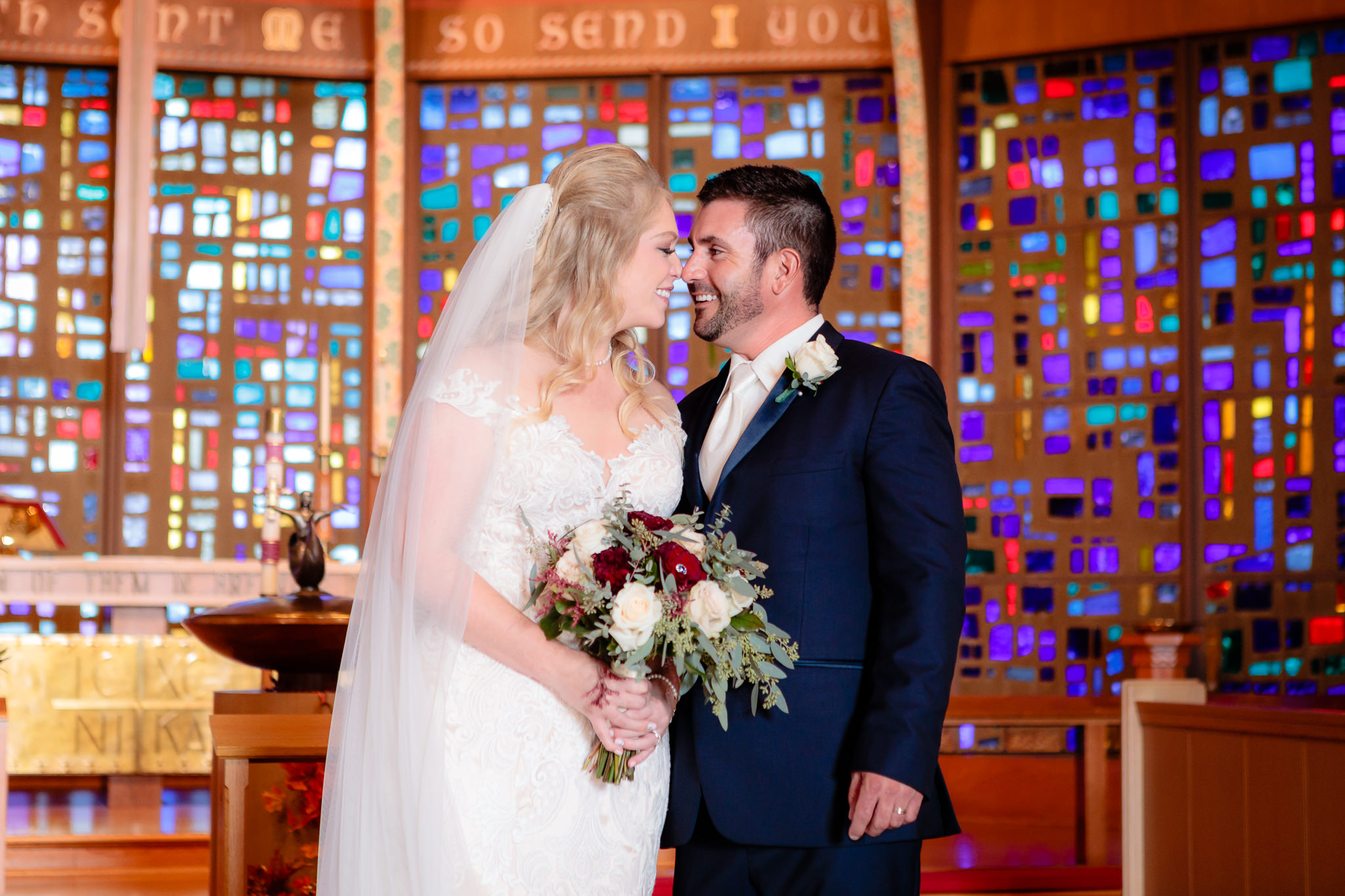 Newlyweds nuzzle noses on the altar of Zion Lutheran Church in Penn Hills