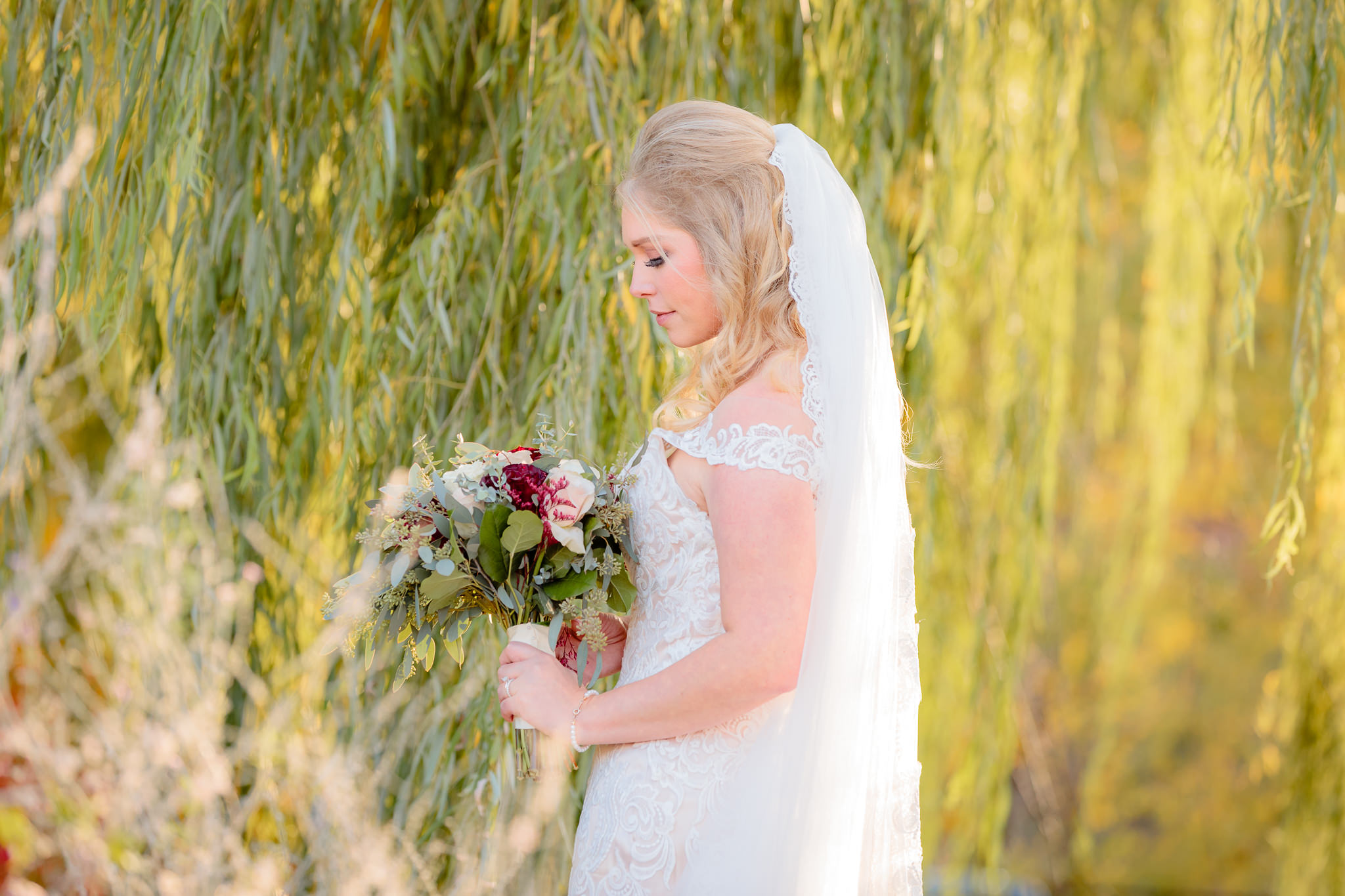 Side portrait of the bride in an allure wedding dress at Riverside Landing in Oakmont