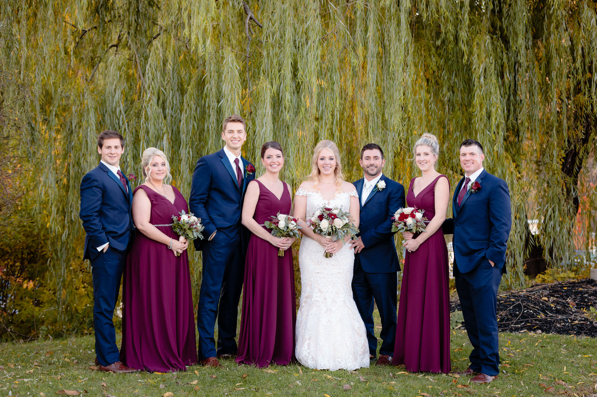 Bridal party under a willow tree at Riverside Landing in Oakmont
